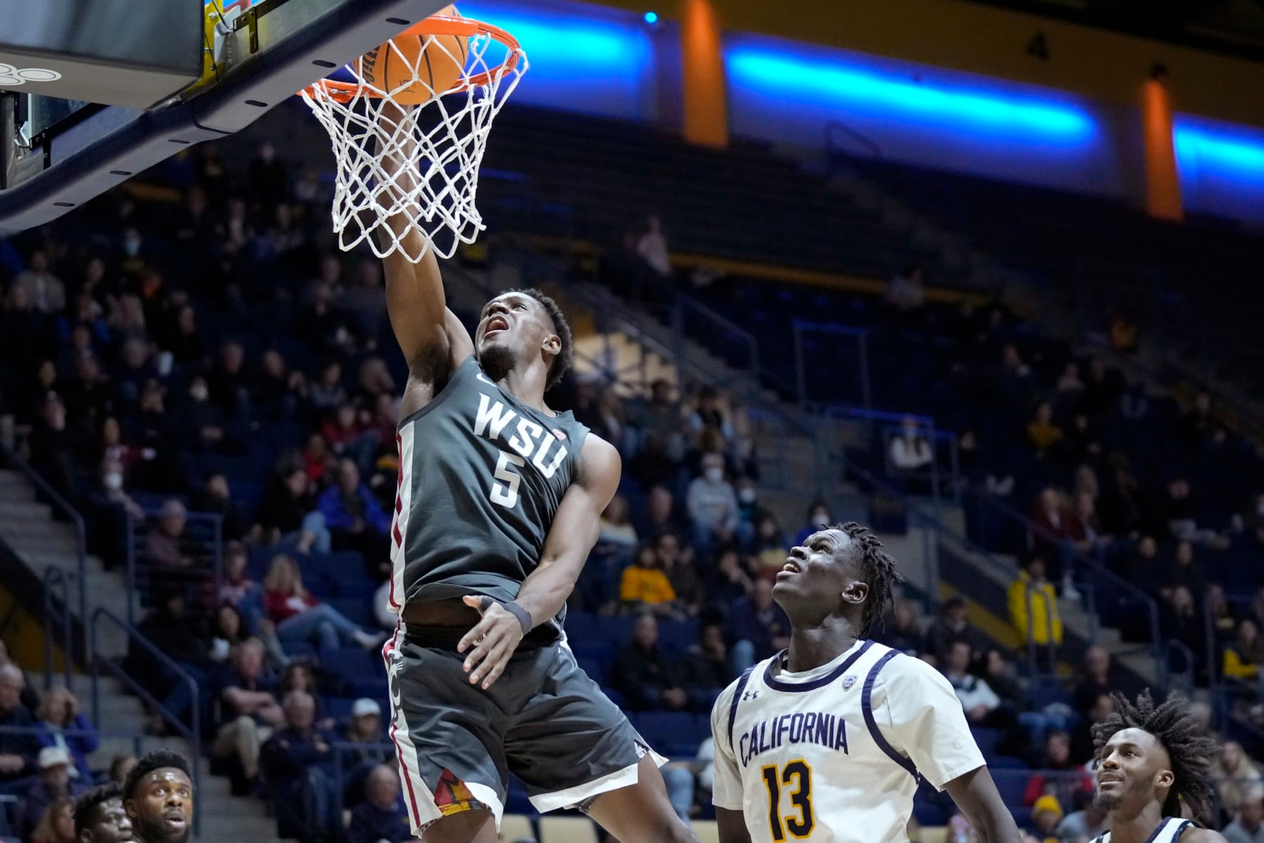 Washington State guard TJ Bamba (5) dunks in front of California forward Kuany Kuany (13) during the second half of an NCAA college basketball game in Berkeley, Calif., Saturday, Feb. 25, 2023. (AP Photo/Jeff Chiu)