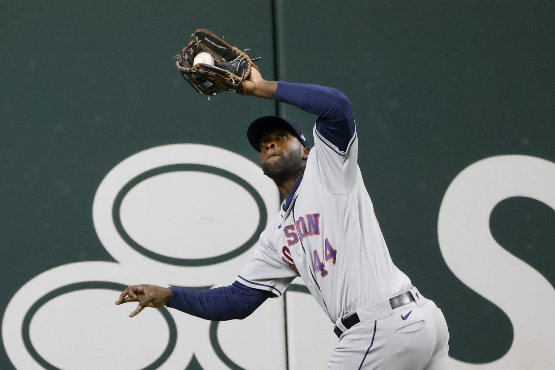 Houston Astros left fielder Yordan Alvarez (44) fields a ball against the Texas Rangers during the eighth inning of a baseball game Monday, April 25, 2022, in Arlington, Texas. (AP Photo/Michael Ainsworth)