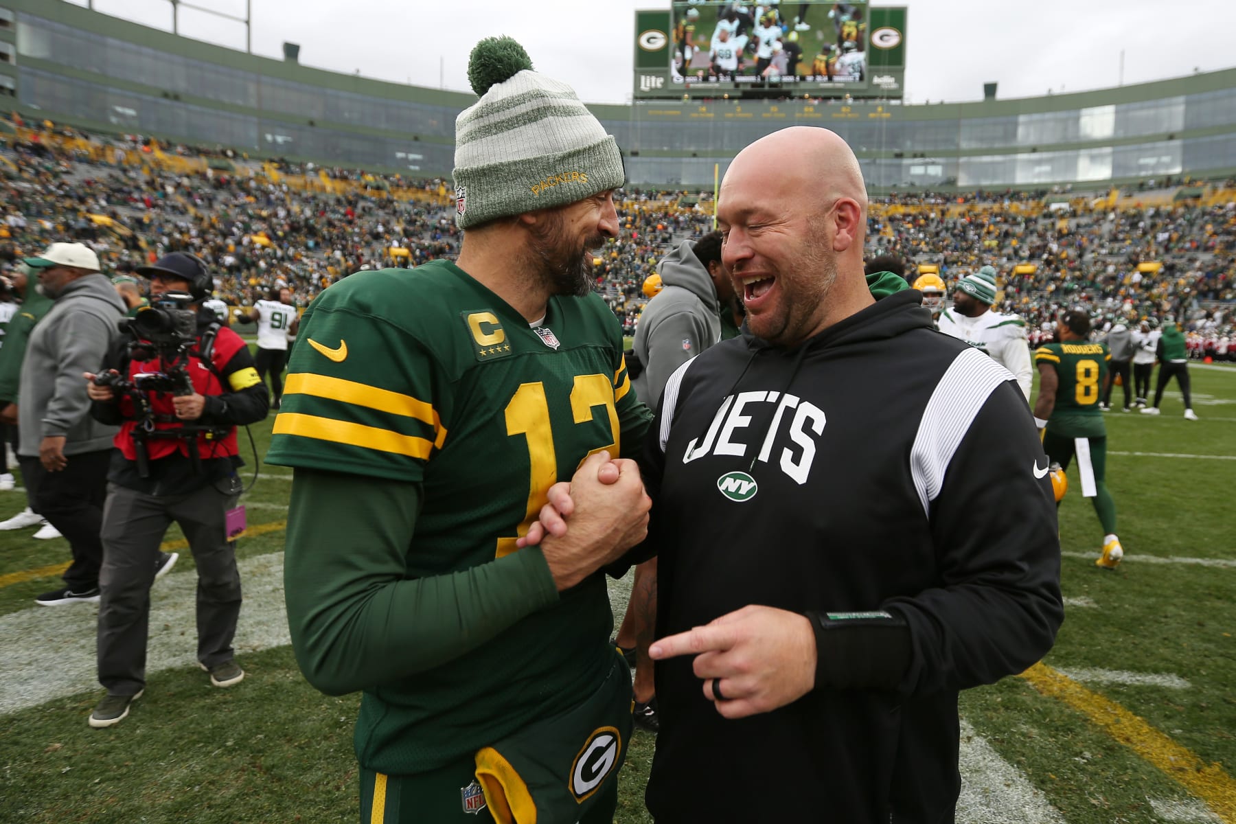 GREEN BAY, WI - OCTOBER 16: Green Bay Packers quarterback Aaron Rodgers (12) talks with New York Jets defensive line coach Aaron Whitecotton during a game between the Green Bay Packers and the New York Jets at Lambeau Field on October 16, 2022 in Green Bay, WI. (Photo by Larry Radloff/Icon Sportswire via Getty Images)