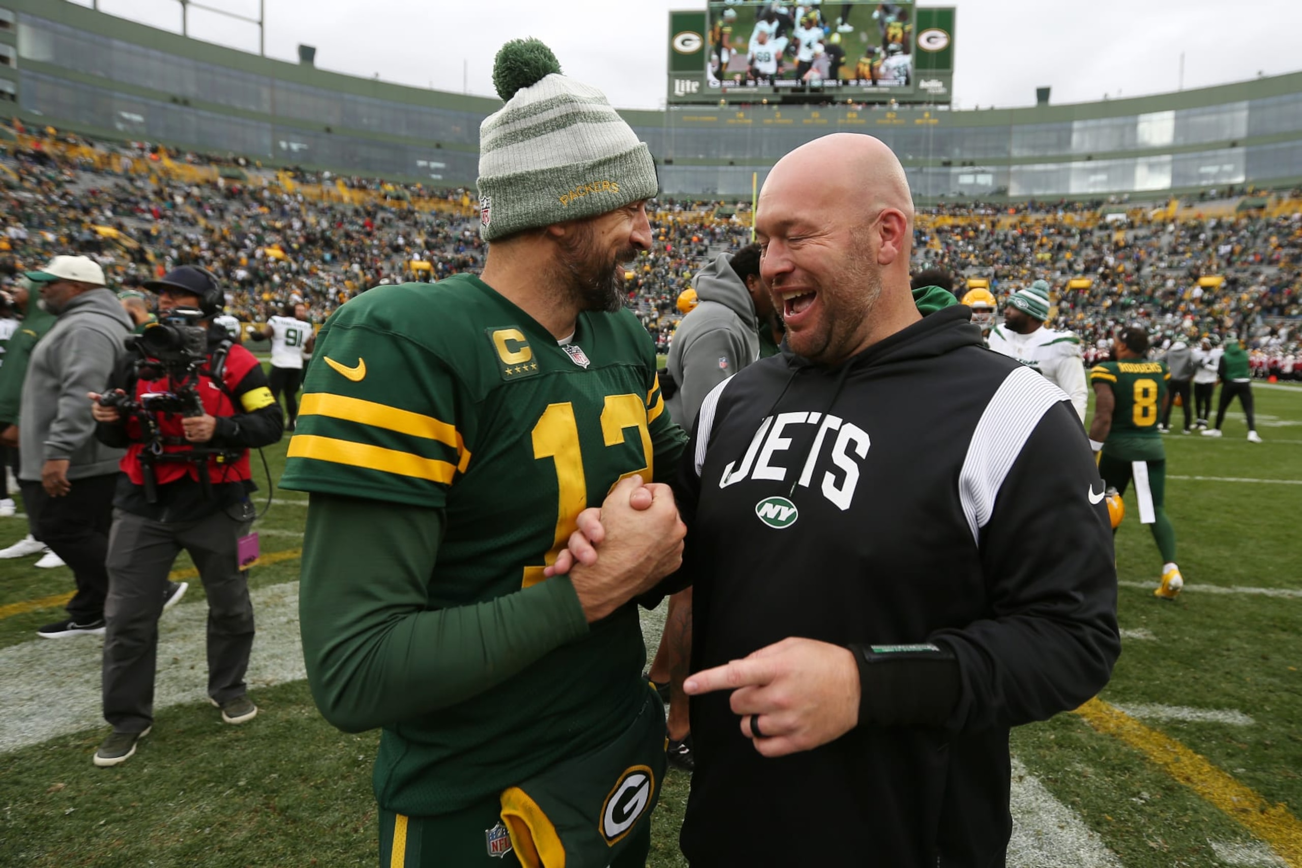 GREEN BAY, WI - OCTOBER 16: Green Bay Packers quarterback Aaron Rodgers (12) talks with New York Jets defensive line coach Aaron Whitecotton during a game between the Green Bay Packers and the New York Jets at Lambeau Field on October 16, 2022 in Green Bay, WI. (Photo by Larry Radloff/Icon Sportswire via Getty Images)