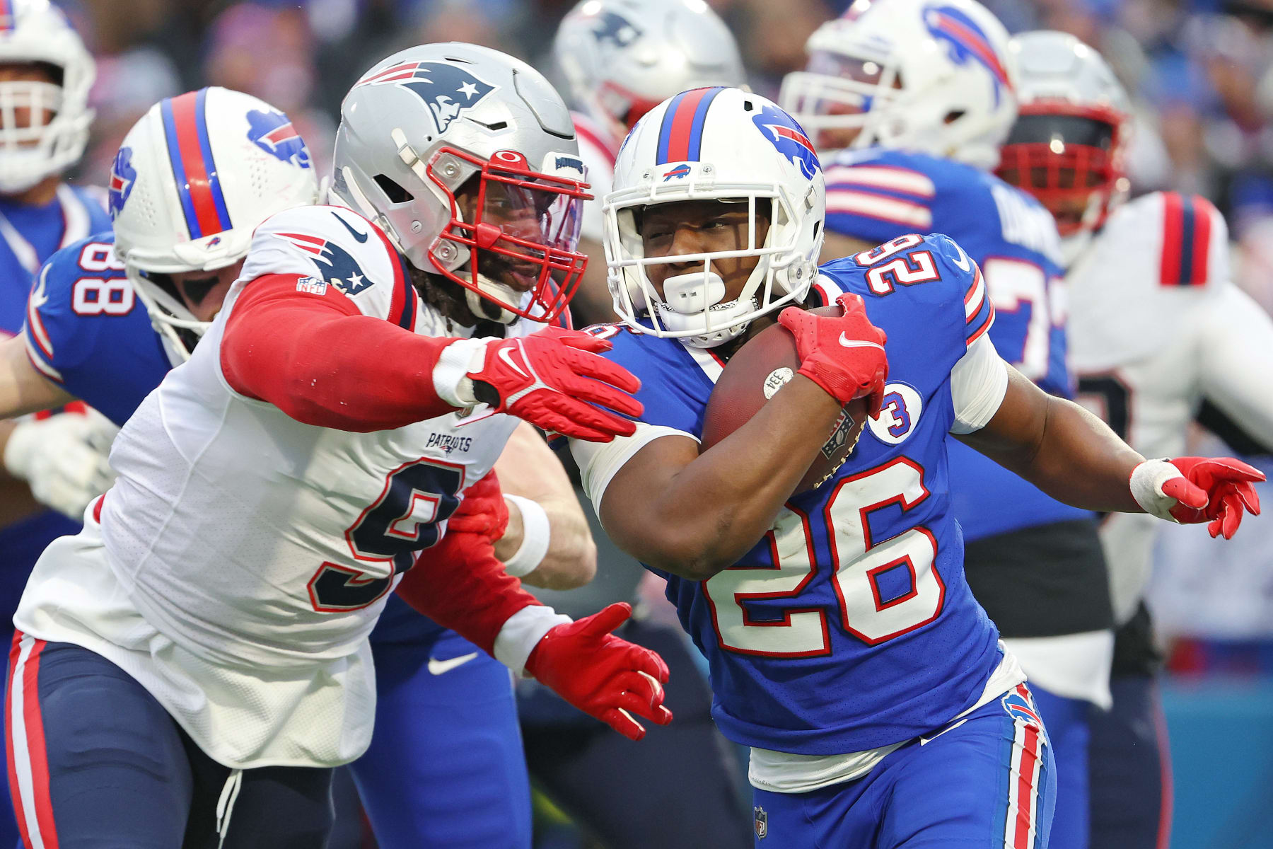 ORCHARD PARK, NEW YORK - JANUARY 08: Matthew Judon #9 of the New England Patriots tackles Devin Singletary #26 of the Buffalo Bills during the third quarter at Highmark Stadium on January 08, 2023 in Orchard Park, New York. (Photo by Timothy T Ludwig/Getty Images)