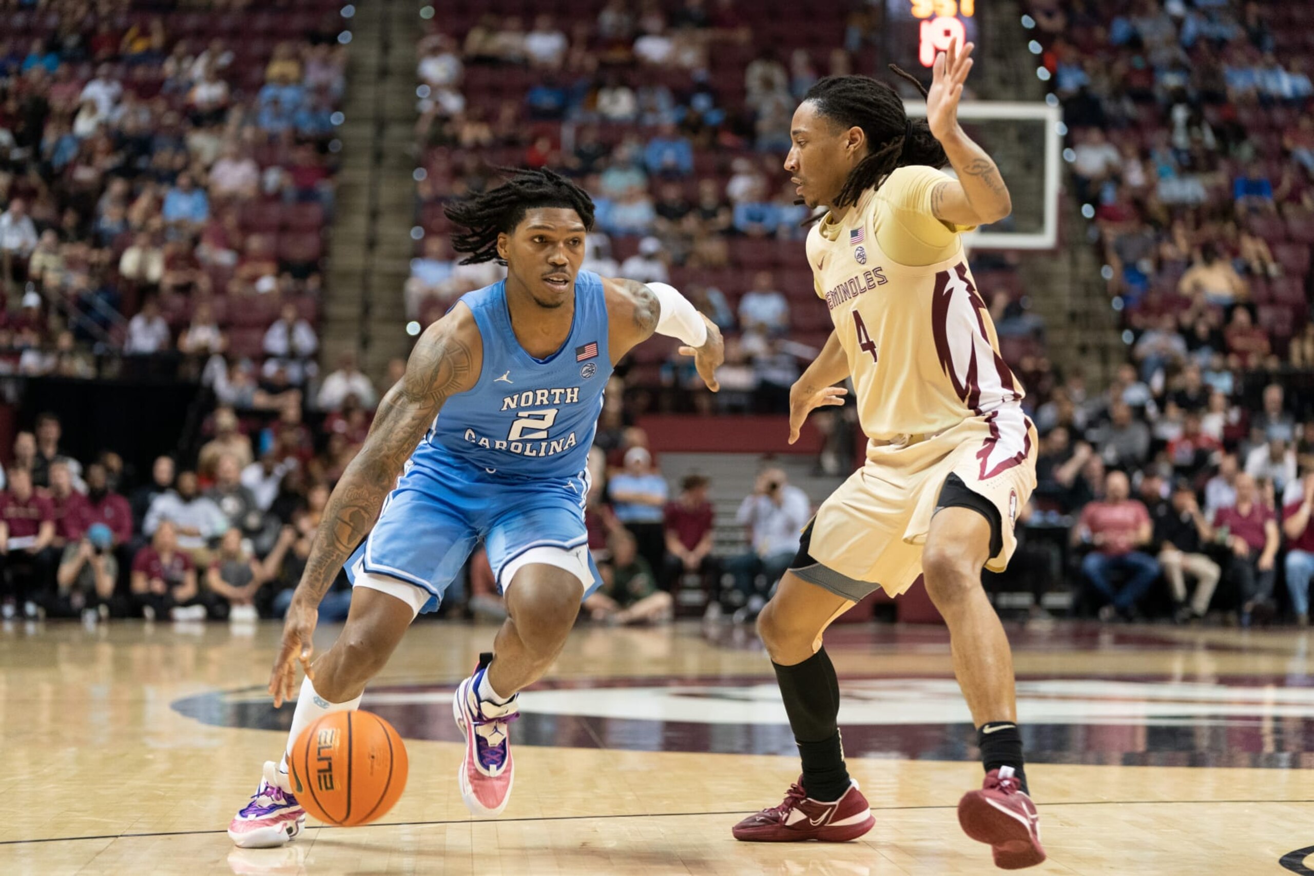 TALLAHASSEE, FL - FEBRUARY 27: North Carolina Tar Heels guard Caleb Love (2) tries to drive by Florida State Seminoles guard Caleb Mills (4) during a college basketball game at the Civic Center in Tallahassee FL on February 27, 2023.(Photo by Chris Leduc/Icon Sportswire via Getty Images)