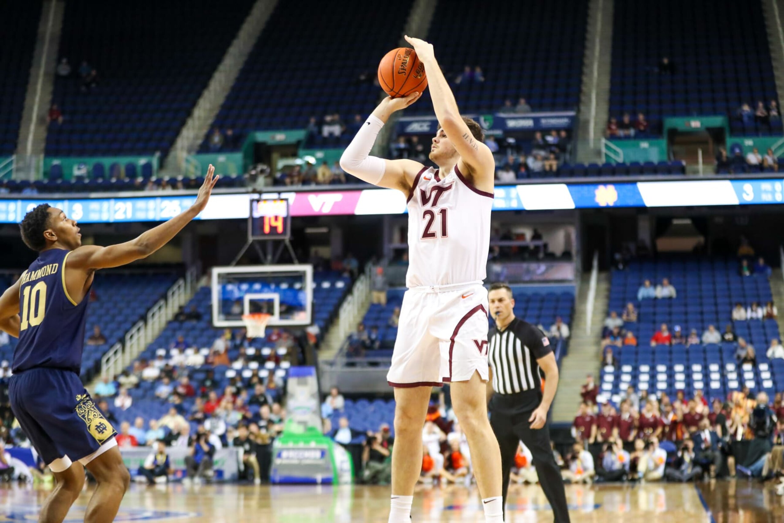 GREENSBORO, NC - MARCH 07: Grant Basile (21) of the Virginia Tech Hokies shoots the ball over Marcus Hammond (10) of the Notre Dame Fighting Irish during the ACC Tournament on March 7, 2023 at Greensboro Coliseum in Greensboro, NC. (Photo by David Jensen/Icon Sportswire via Getty Images)