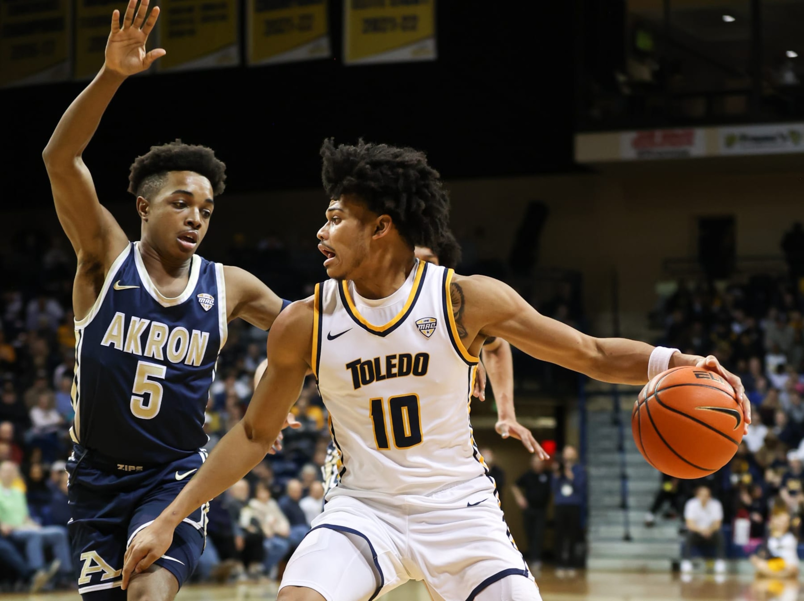 TOLEDO, OH - FEBRUARY 21:  Toledo Rockets guard RayJ Dennis (10) drives to the basket against Akron Zips guard Tavari Johnson (5) during the first half of a Mid-American Conference regular season college basketball game between the Akron Zips and the Toledo Rockets on February 21, 2023 at Savage Arena in Toledo, Ohio.  Photo by Scott W. Grau/Icon Sportswire via Getty Images)