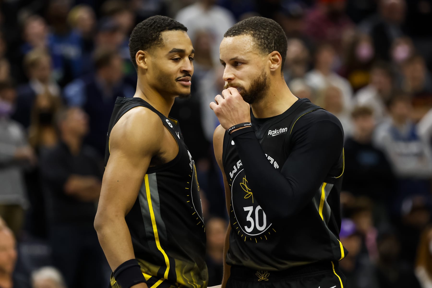 MINNEAPOLIS, MN - FEBRUARY 01: Jordan Poole #3 interacts with Stephen Curry #30 of the Golden State Warriors in the fourth quarter of the game against the Minnesota Timberwolves at Target Center on February 01, 2023 in Minneapolis, Minnesota. The Timberwolves defeated the Warriors 119-114 in overtime. NOTE TO USER: User expressly acknowledges and agrees that, by downloading and or using this Photograph, user is consenting to the terms and conditions of the Getty Images License Agreement. (Photo by David Berding/Getty Images)
