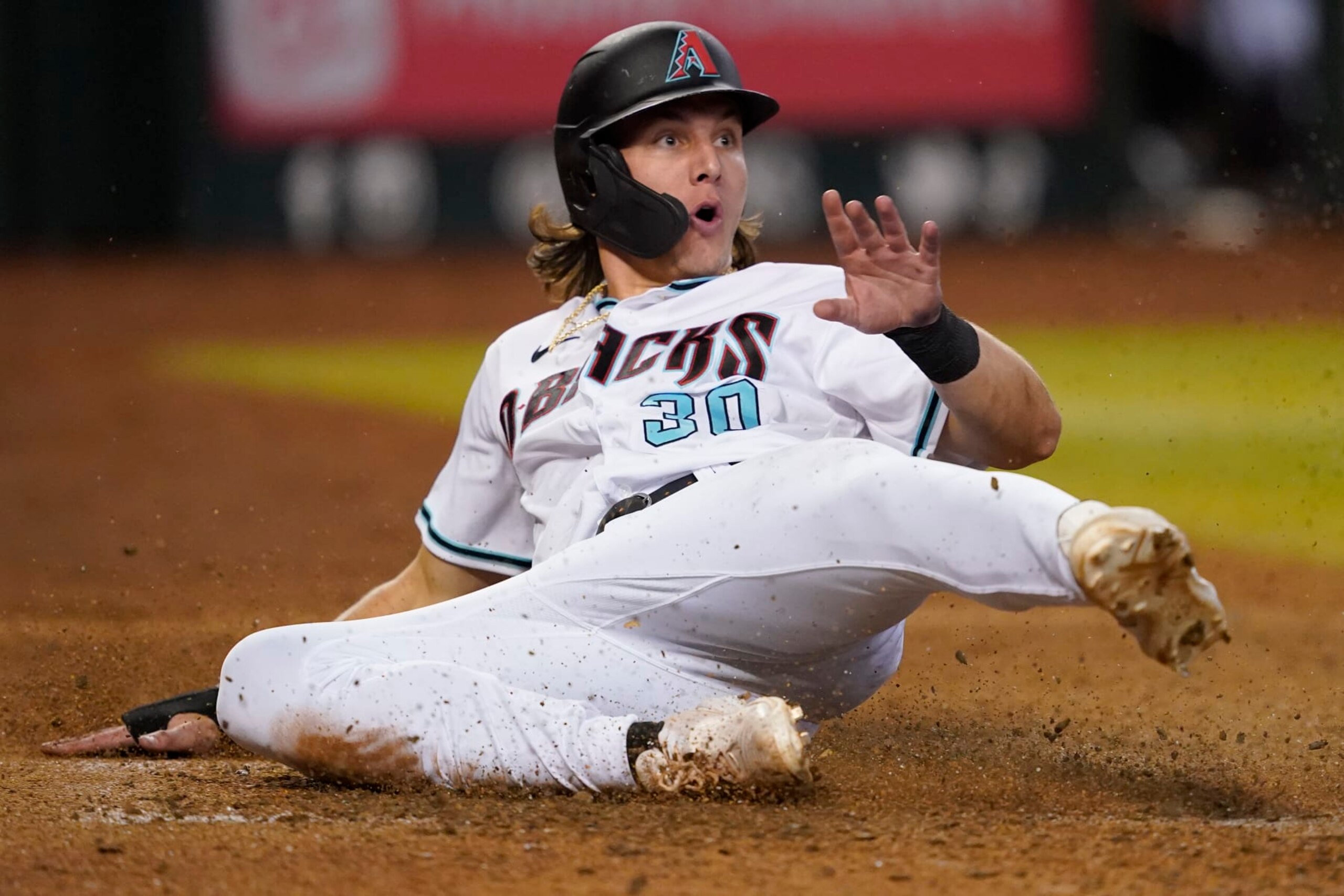 Arizona Diamondbacks' Jake McCarthy (30) looks at the umpire after being called out at the plate on a fielders choice hit into by Daulton Varsho during the eighth inning of a baseball game against the San Diego Padres, Thursday, Sept. 15, 2022, in Phoenix. (AP Photo/Matt York)