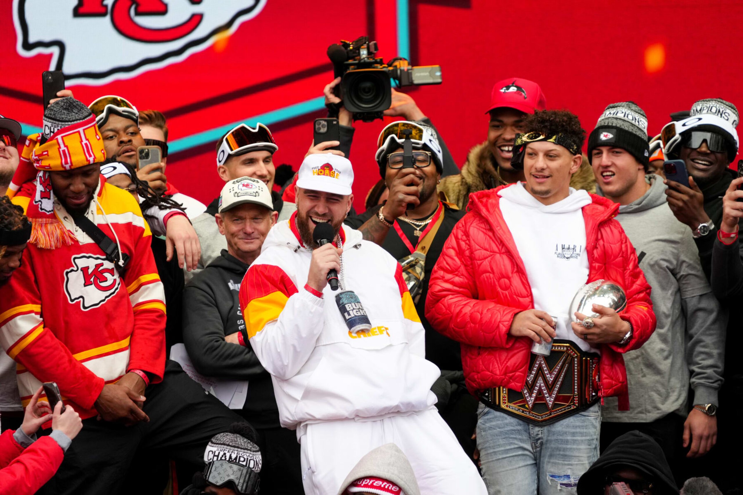 KANSAS CITY, MISSOURI - FEBRUARY 15: Travis Kelce #87 and Patrick Mahomes #15 of the Kansas City Chiefs celebrate on stage with teammates during the Kansas City Chiefs Super Bowl LVII victory parade on February 15, 2023 in Kansas City, Missouri. (Photo by Jay Biggerstaff/Getty Images)