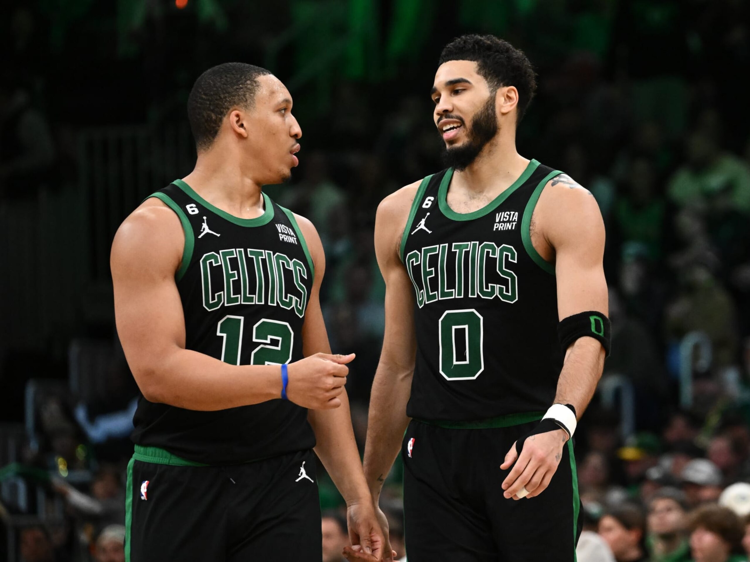 BOSTON, MASSACHUSETTS - FEBRUARY 10: Jayson Tatum #0 of the Boston Celtics talks with teammate, Grant Williams #12, during a timeout in the fourth quarter of a game against the Charlotte Hornets at the TD Garden on February 10, 2023 in Boston, Massachusetts. NOTE TO USER: User expressly acknowledges and agrees that, by downloading and or using this photograph, User is consenting to the terms and conditions of the Getty Images License Agreement. (Photo by Brian Fluharty/Getty Images)