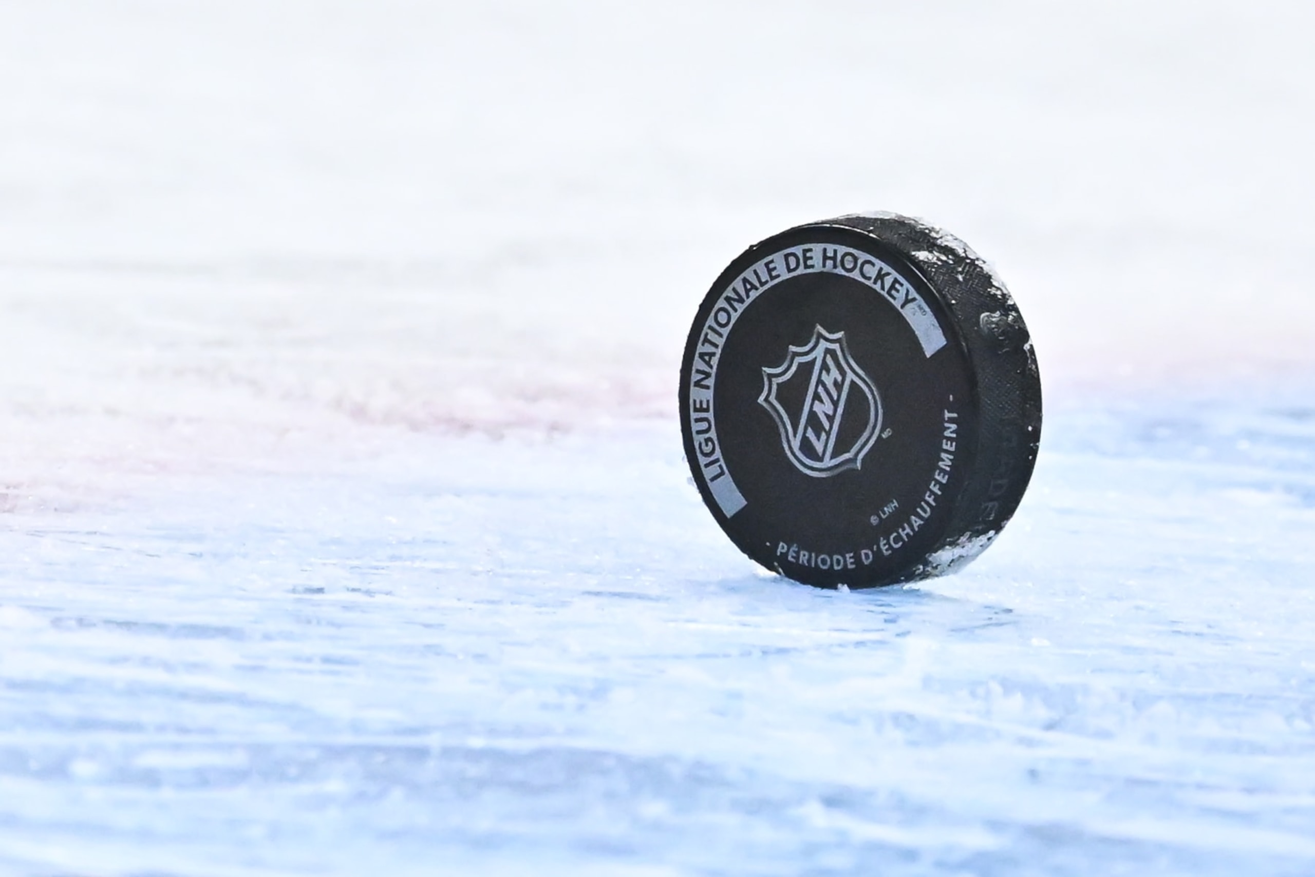 MONTREAL, CANADA - JANUARY 19:  A puck sits on the ice with the NHL crest during warm-ups prior to the game between the Montreal Canadiens and the Florida Panthers at Centre Bell on January 19, 2023 in Montreal, Quebec, Canada.  The Florida Panthers defeated the Montreal Canadiens 6-2.  (Photo by Minas Panagiotakis/Getty Images)