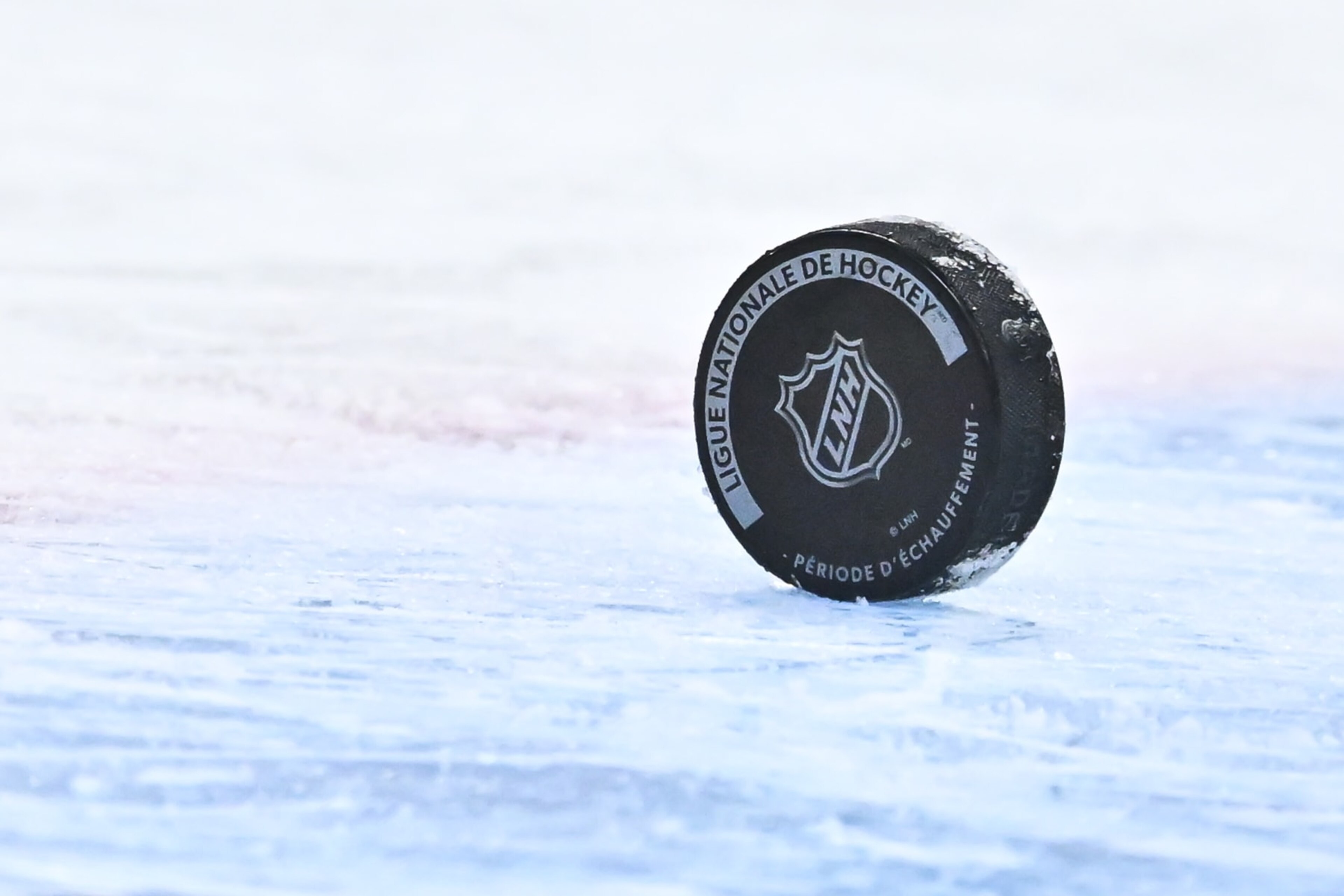 MONTREAL, CANADA - JANUARY 19: A puck sits on the ice with the NHL crest during warm-ups prior to the game between the Montreal Canadiens and the Florida Panthers at Centre Bell on January 19, 2023 in Montreal, Quebec, Canada. The Florida Panthers defeated the Montreal Canadiens 6-2. (Photo by Minas Panagiotakis/Getty Images) MONTREAL, CANADA - JANUARY 19: A puck sits on the ice with the NHL crest during warm-ups prior to the game between the Montreal Canadiens and the Florida Panthers at Centre Bell on January 19, 2023 in Montreal, Quebec, Canada. The Florida Panthers defeated the Montreal Canadiens 6-2. (Photo by Minas Panagiotakis/Getty Images)