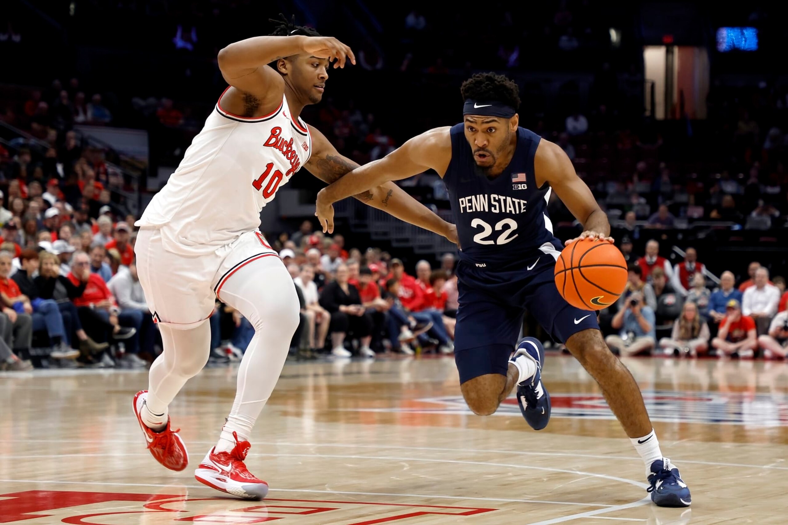 COLUMBUS, OH - FEBRUARY 23:  Jalen Pickett #22 of the Penn State Nittany Lions drives the ball against the defense of Brice Sensabaugh #10 of the Ohio State Buckeyes during the second half at the Jerome Schottenstein Center on February 23, 2023 in Columbus, Ohio. Penn State defeated Ohio State 75-71. (Photo by Kirk Irwin/Getty Images)