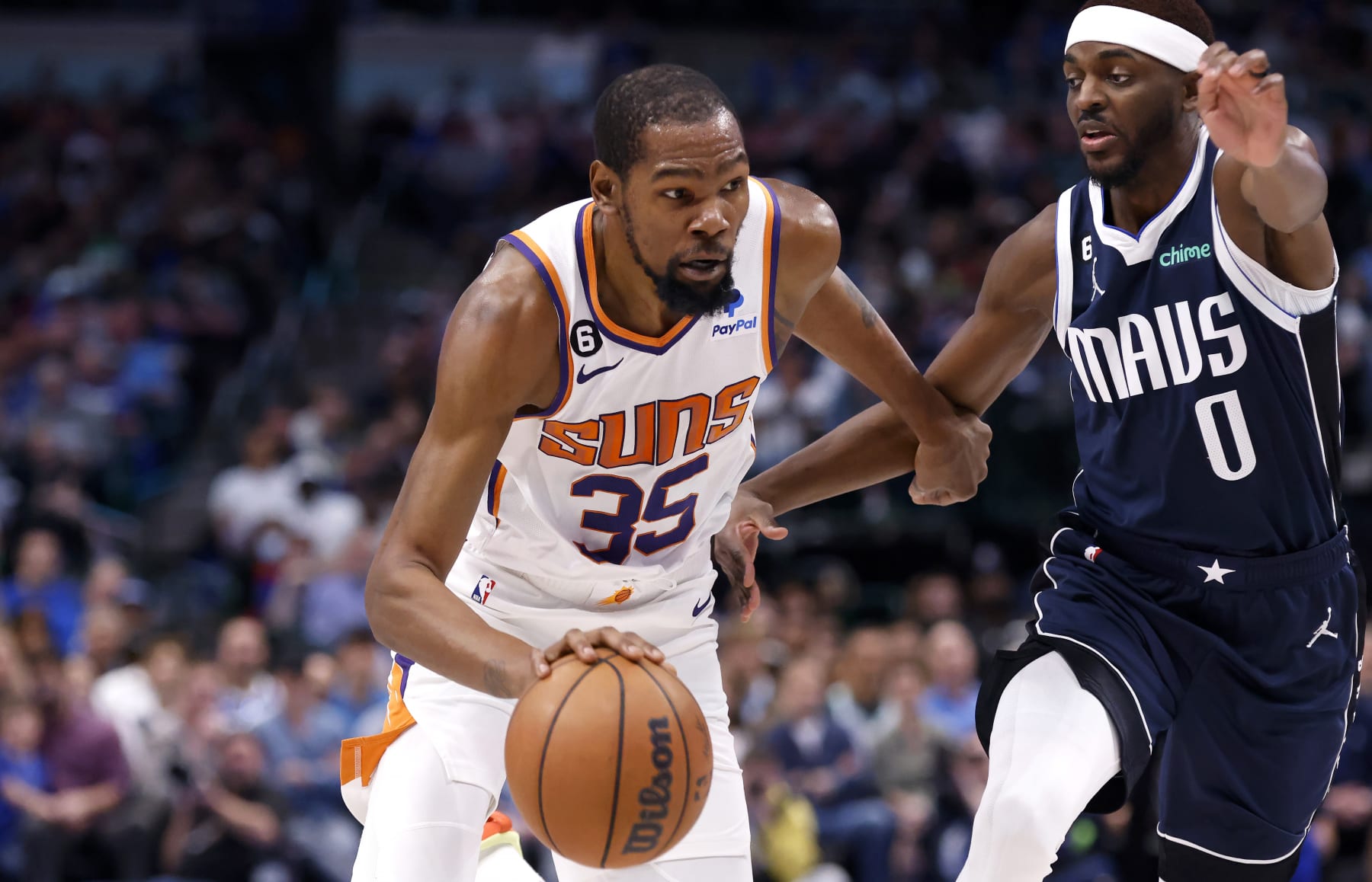 DALLAS, TX - MARCH 5: Kevin Durant #35 of the Phoenix Suns goes to the basket as Justin Holiday #0 of the Dallas Mavericks defends in the second half of the game at American Airlines Center on March 5, 2023 in Dallas, Texas. The Suns won 130-126. NOTE TO USER: User expressly acknowledges and agrees that, by downloading and or using this photograph, User is consenting to the terms and conditions of the Getty Images License Agreement. (Photo by Ron Jenkins/Getty Images)