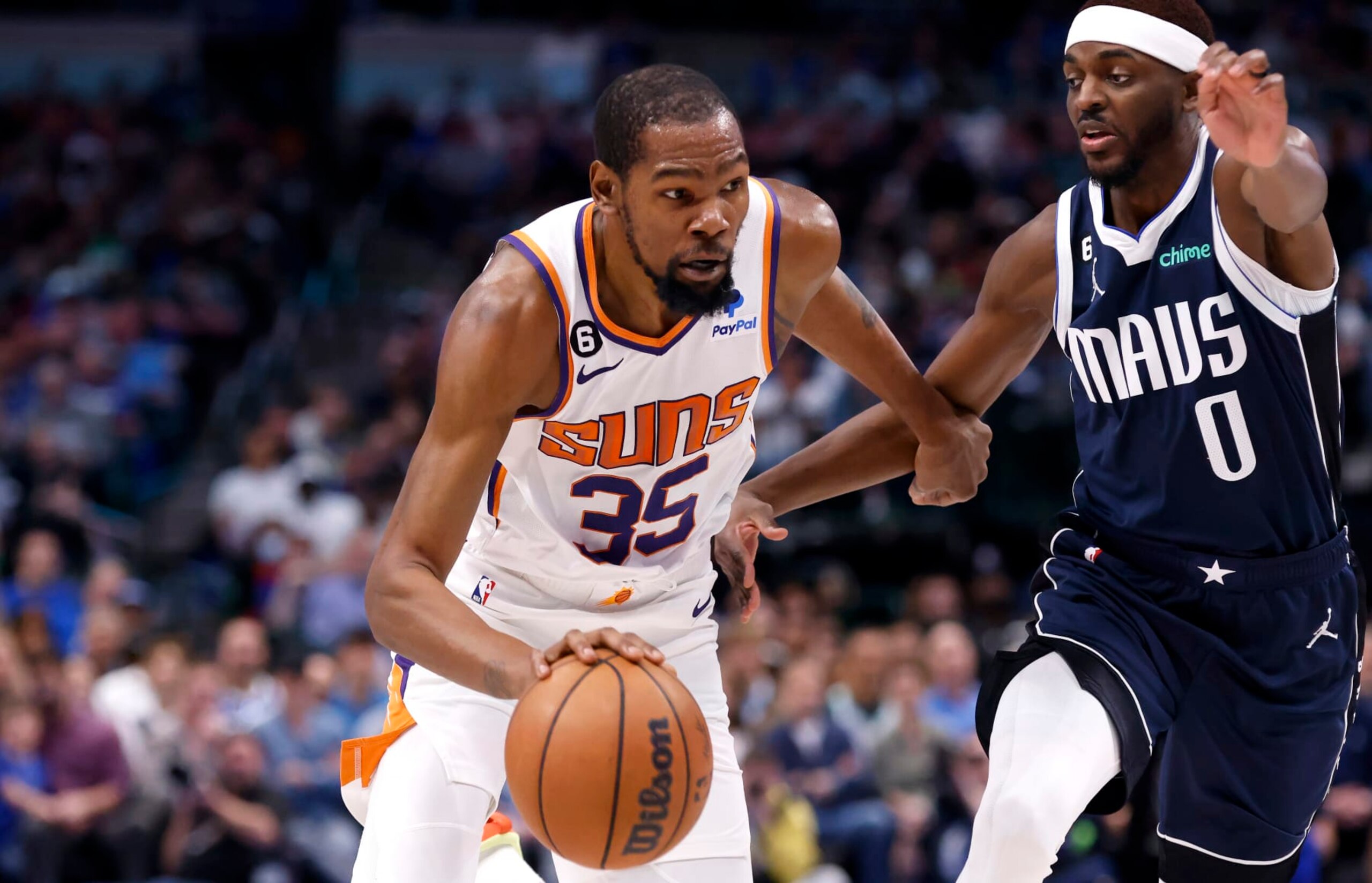DALLAS, TX - MARCH 5: Kevin Durant #35 of the Phoenix Suns goes to the basket as Justin Holiday #0 of the Dallas Mavericks defends in the second half of the game at American Airlines Center on March 5, 2023 in Dallas, Texas. The Suns won 130-126. NOTE TO USER: User expressly acknowledges and agrees that, by downloading and or using this photograph, User is consenting to the terms and conditions of the Getty Images License Agreement. (Photo by Ron Jenkins/Getty Images)