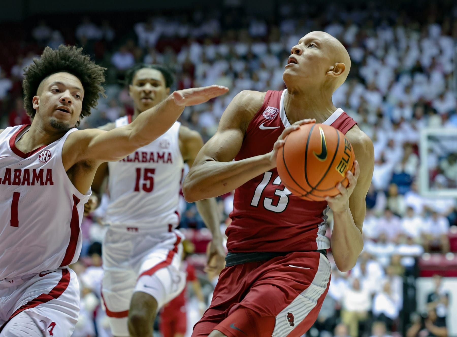 TUSCALOOSA, AL - FEBRUARY 25: Jordan Walsh #13 of the Arkansas Razorbacks drives to the basket during the first half against Mark Sears #1 of the Alabama Crimson Tide at Coleman Coliseum on February 25, 2023 in Tuscaloosa, Alabama. (Photo by Brandon Sumrall/Getty Images)