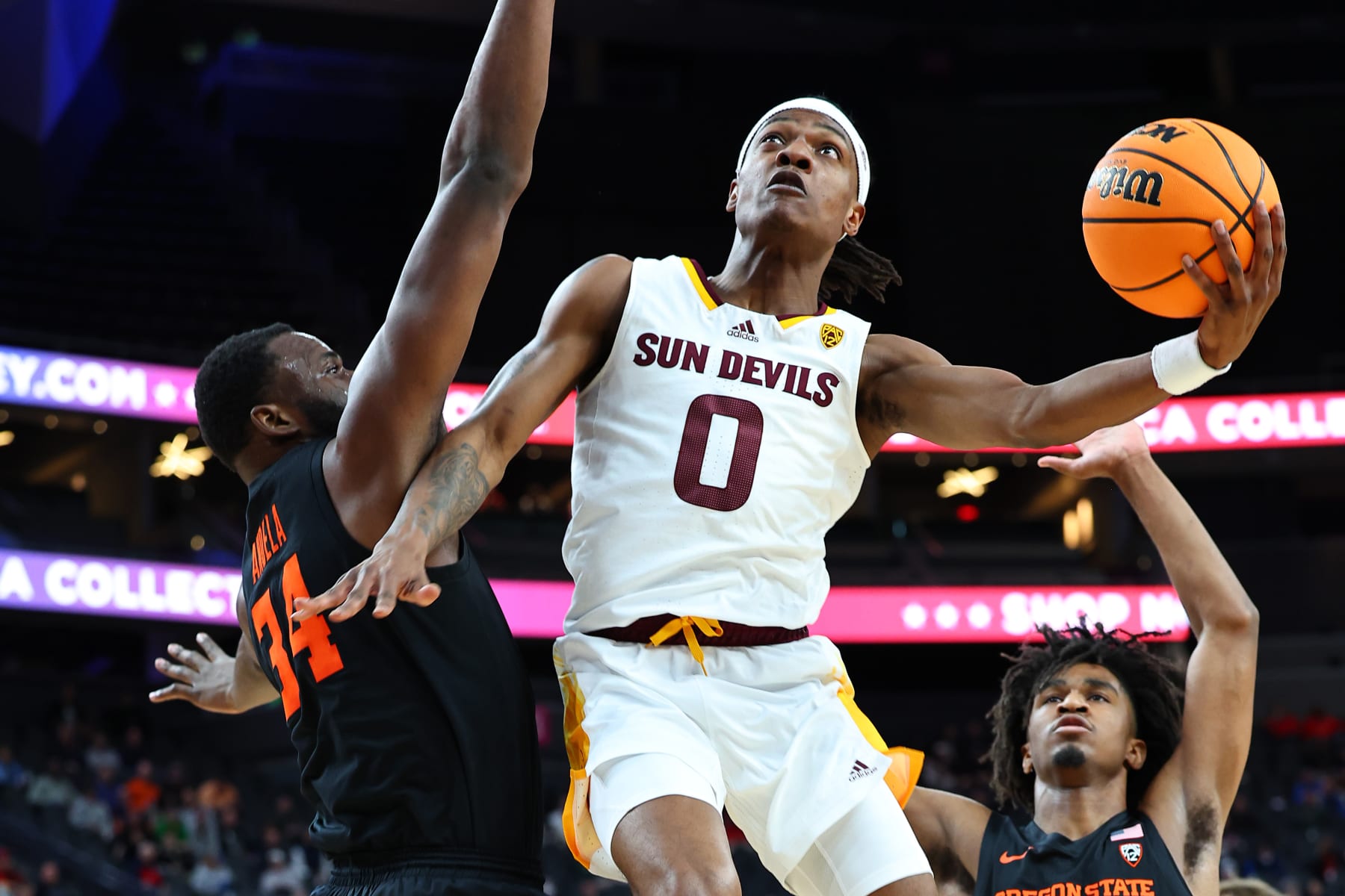 LAS VEGAS, NEVADA - MARCH 08:  DJ Horne #0 of the Arizona State Sun Devils goes to the basket against Rodrigue Andela #34 of the Oregon State Beavers in the first half during round one of the Pac-12 basketball tournament at T-Mobile Arena on March 08, 2023 in Las Vegas, Nevada. (Photo by Leon Bennett/Getty Images)
