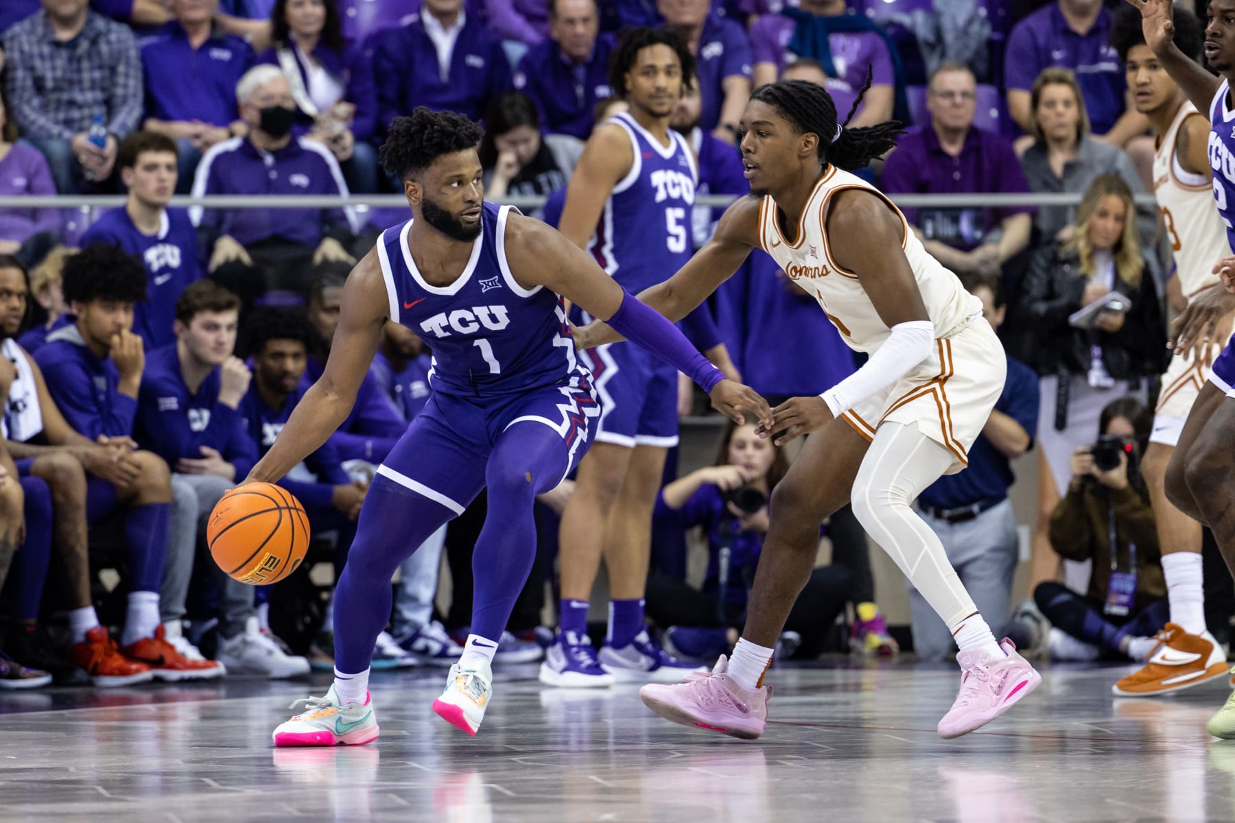 FORT WORTH, TX - FEBRUARY 11: TCU Horned Frogs guard Mike Miles Jr. (#1) dribbles up court as Texas Longhorns guard Marcus Carr (#5) defends during the college basketball game between the TCU Horned Frogs and Texas Longhorns on March 1, 2023 at Ed & Rae Schollmaier Arena in Fort Worth, Texas.  (Photo by Matthew Visinsky/Icon Sportswire via Getty Images)