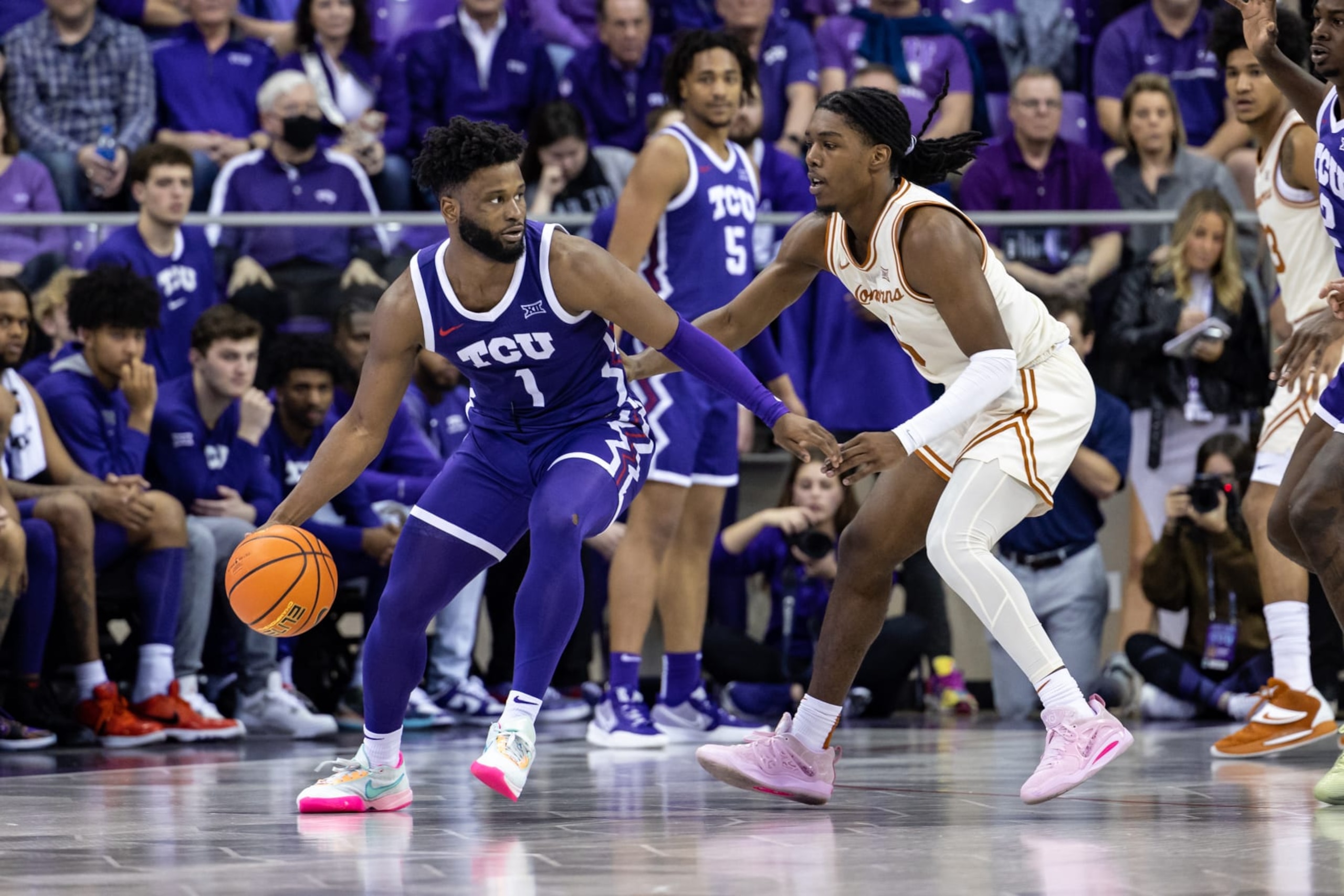 FORT WORTH, TX - FEBRUARY 11: TCU Horned Frogs guard Mike Miles Jr. (#1) dribbles up court as Texas Longhorns guard Marcus Carr (#5) defends during the college basketball game between the TCU Horned Frogs and Texas Longhorns on March 1, 2023 at Ed & Rae Schollmaier Arena in Fort Worth, Texas.  (Photo by Matthew Visinsky/Icon Sportswire via Getty Images)