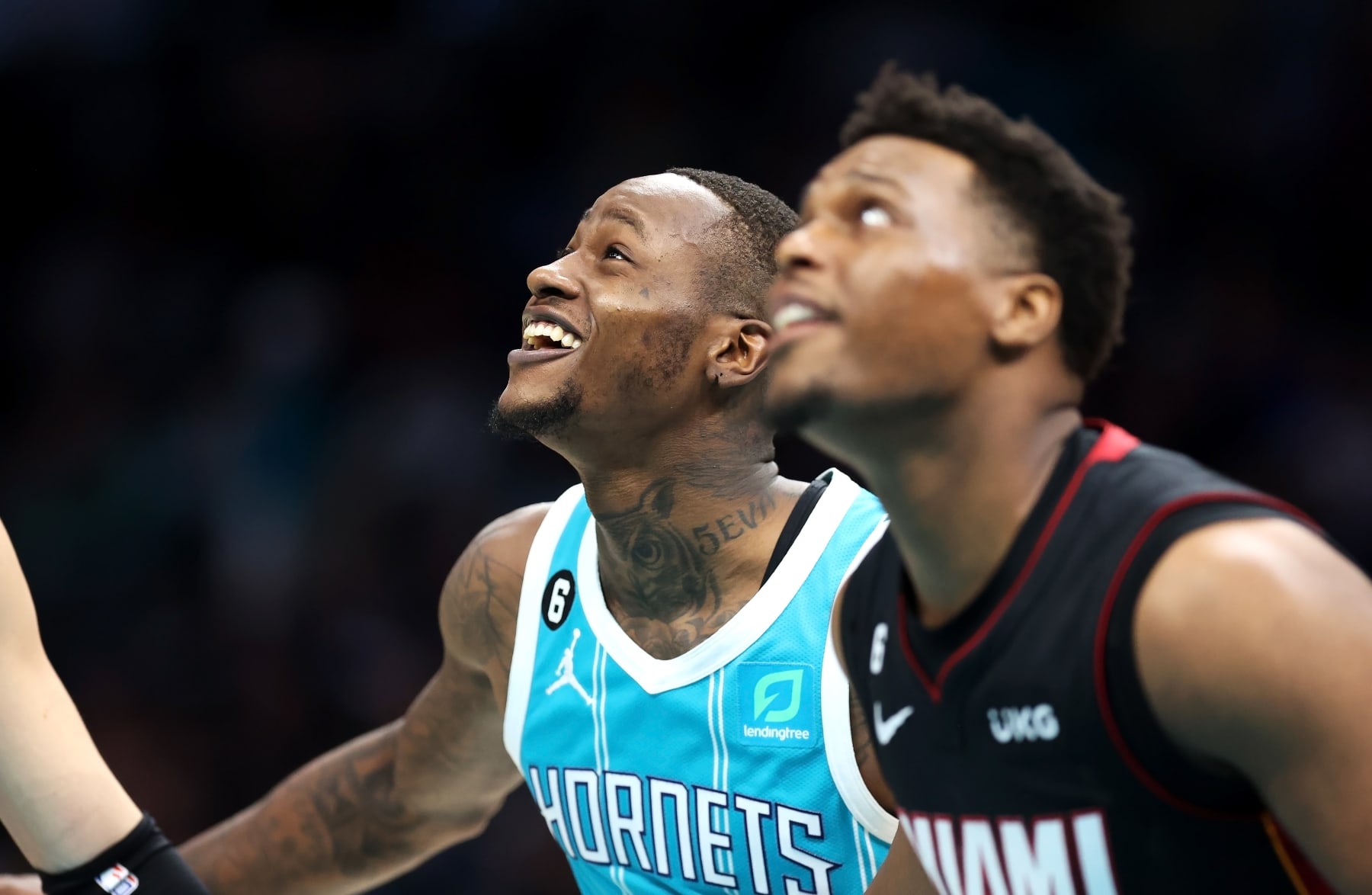 CHARLOTTE, NORTH CAROLINA - JANUARY 29: Terry Rozier #3 of the Charlotte Hornets shares a laugh with Kyle Lowry #7 of the Miami Heat while talking during a free throw during the second quarter of a basketball game at Spectrum Center on January 29, 2023 in Charlotte, North Carolina. NOTE TO USER: User expressly acknowledges and agrees that, by downloading and or using this photograph, User is consenting to the terms and conditions of the Getty Images License Agreement. (Photo by David Jensen/Getty Images)