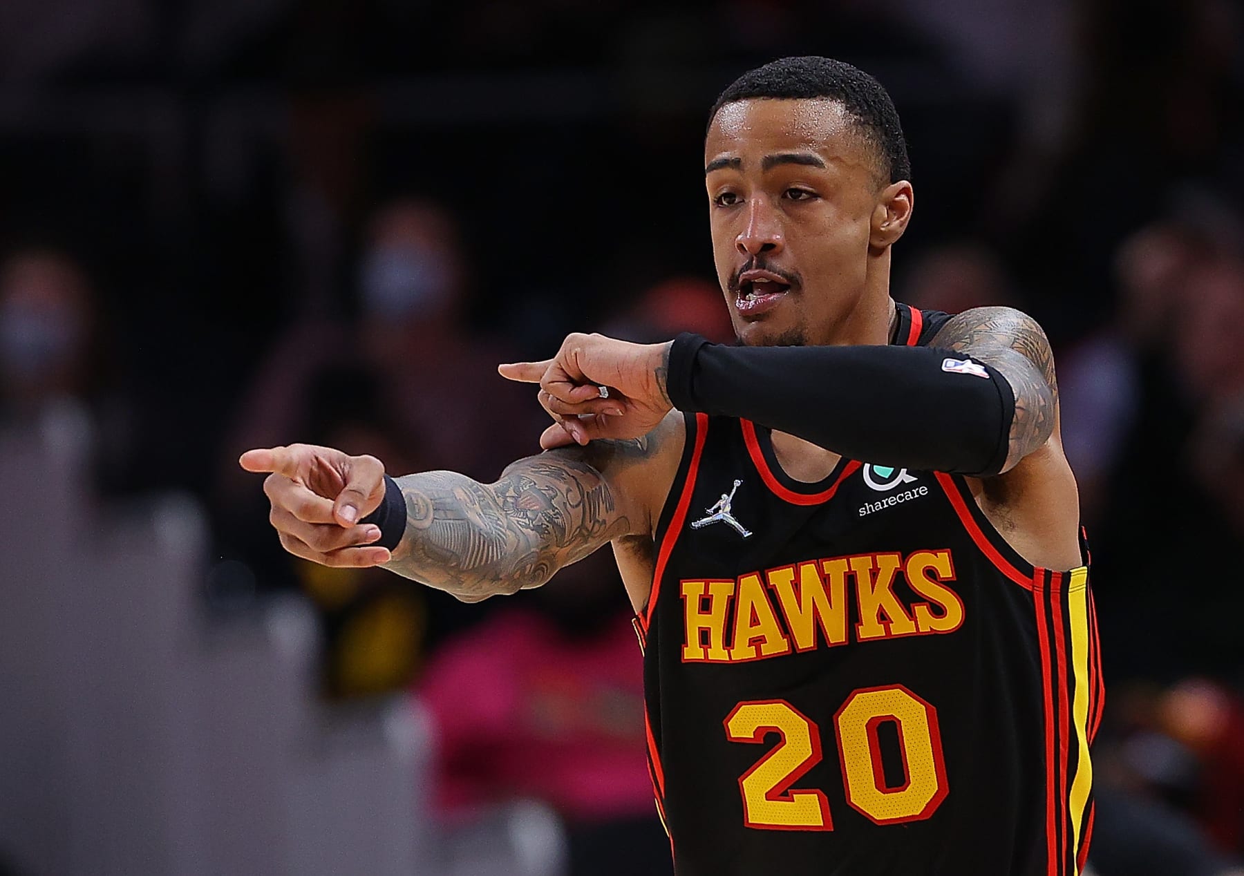 ATLANTA, GEORGIA - FEBRUARY 08:  John Collins #20 of the Atlanta Hawks reacts after hitting a three-point basket against the Indiana Pacers during the first half at State Farm Arena on February 08, 2022 in Atlanta, Georgia.  NOTE TO USER: User expressly acknowledges and agrees that, by downloading and or using this photograph, User is consenting to the terms and conditions of the Getty Images License Agreement.  (Photo by Kevin C. Cox/Getty Images)