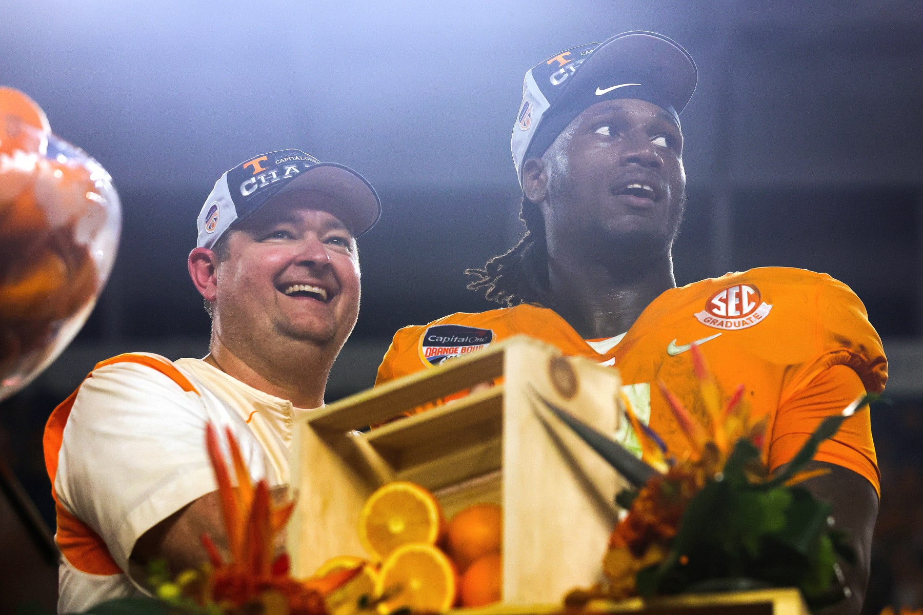 MIAMI GARDENS, FLORIDA - DECEMBER 30: (L-R) Head coach Josh Heupel and Joe Milton III #7 of the Tennessee Volunteers celebrate on stage after defeating the Clemson Tigers in the Capital One Orange Bowl at Hard Rock Stadium on December 30, 2022 in Miami Gardens, Florida. (Photo by Megan Briggs/Getty Images)