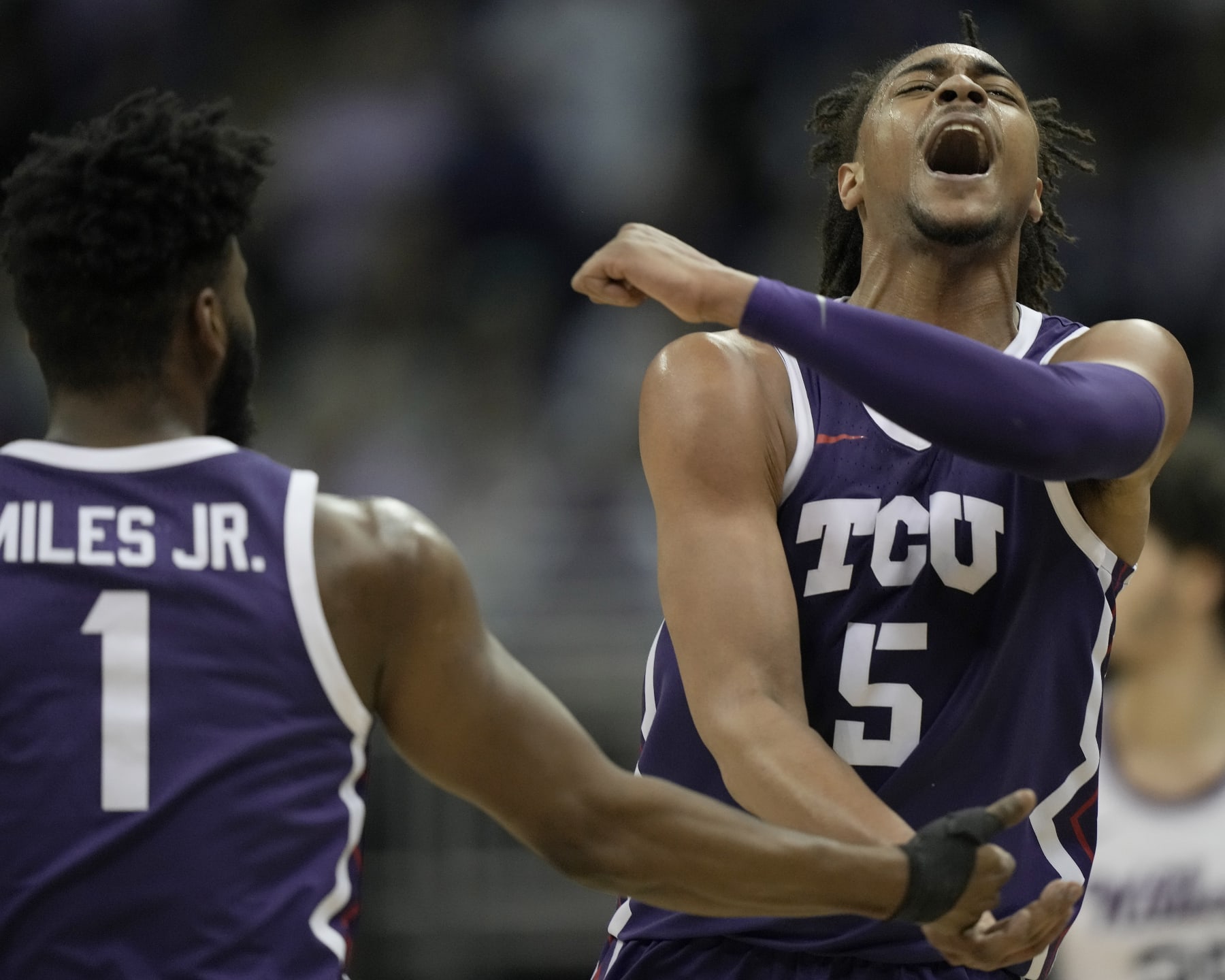 TCU forward Chuck O'Bannon Jr. (5) celebrates with guard Mike Miles Jr. (1) after making a basket during the second half of an NCAA college basketball game against Kansas State in the second round of the Big 12 Conference tournament Thursday, March 9, 2023, in Kansas City, Mo. (AP Photo/Charlie Riedel)