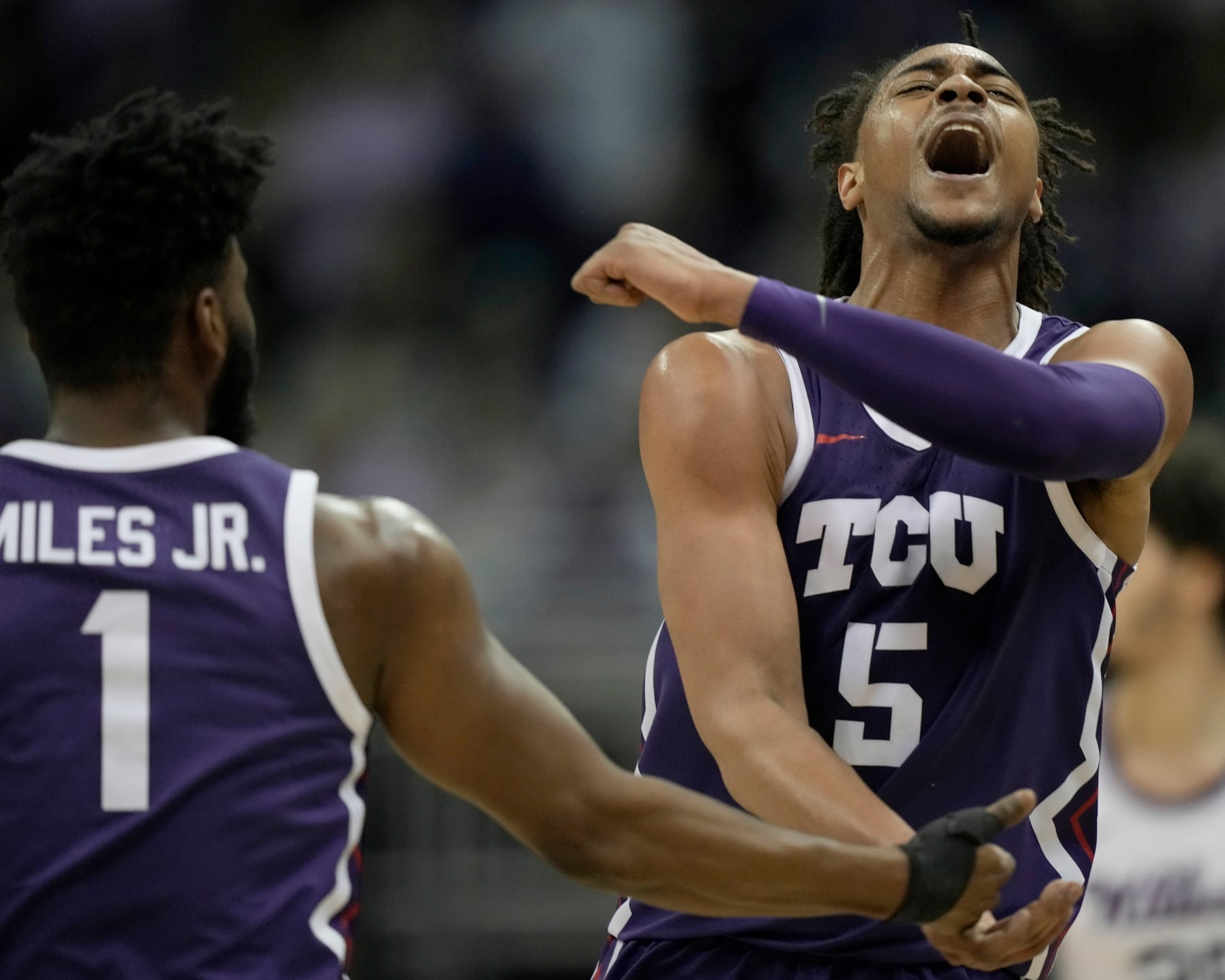 TCU forward Chuck O'Bannon Jr. (5) celebrates with guard Mike Miles Jr. (1) after making a basket during the second half of an NCAA college basketball game against Kansas State in the second round of the Big 12 Conference tournament Thursday, March 9, 2023, in Kansas City, Mo. (AP Photo/Charlie Riedel)