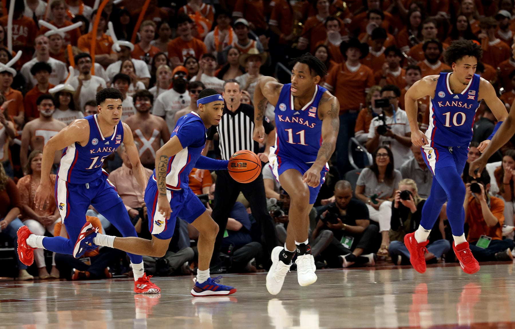 AUSTIN, TEXAS - MARCH 04: Dajuan Harris Jr. #3 (with ball) leads a fast break with Kevin McCullar Jr. #15, MJ Rice #11 and Jalen Wilson #10 of the Kansas Jayhawks in the first half against the Texas Longhorns at Moody Center on March 04, 2023 in Austin, Texas. (Photo by Chris Covatta/Getty Images)