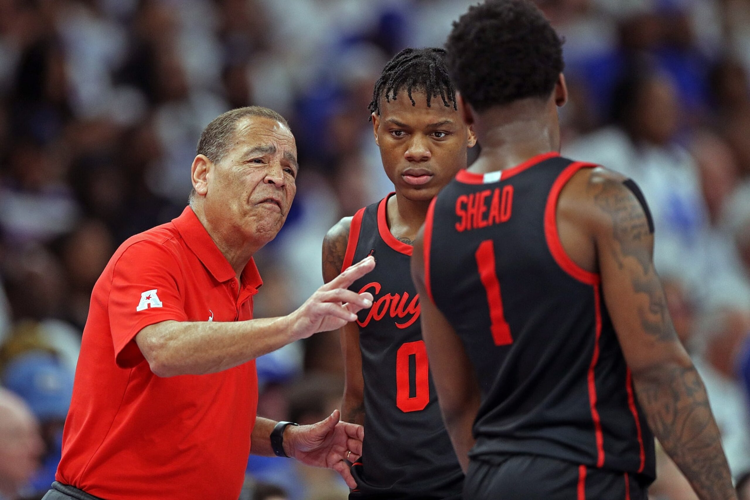 MEMPHIS, TENNESSEE - MARCH 05: Head coach Kelvin Sampson of the Houston Cougars instructs Marcus Sasser #0 and Jamal Shead #1 during the first half against the Memphis Tigers at FedExForum on March 05, 2023 in Memphis, Tennessee. (Photo by Justin Ford/Getty Images) MEMPHIS, TENNESSEE - MARCH 05: Head coach Kelvin Sampson of the Houston Cougars instructs Marcus Sasser #0 and Jamal Shead #1 during the first half against the Memphis Tigers at FedExForum on March 05, 2023 in Memphis, Tennessee. (Photo by Justin Ford/Getty Images)