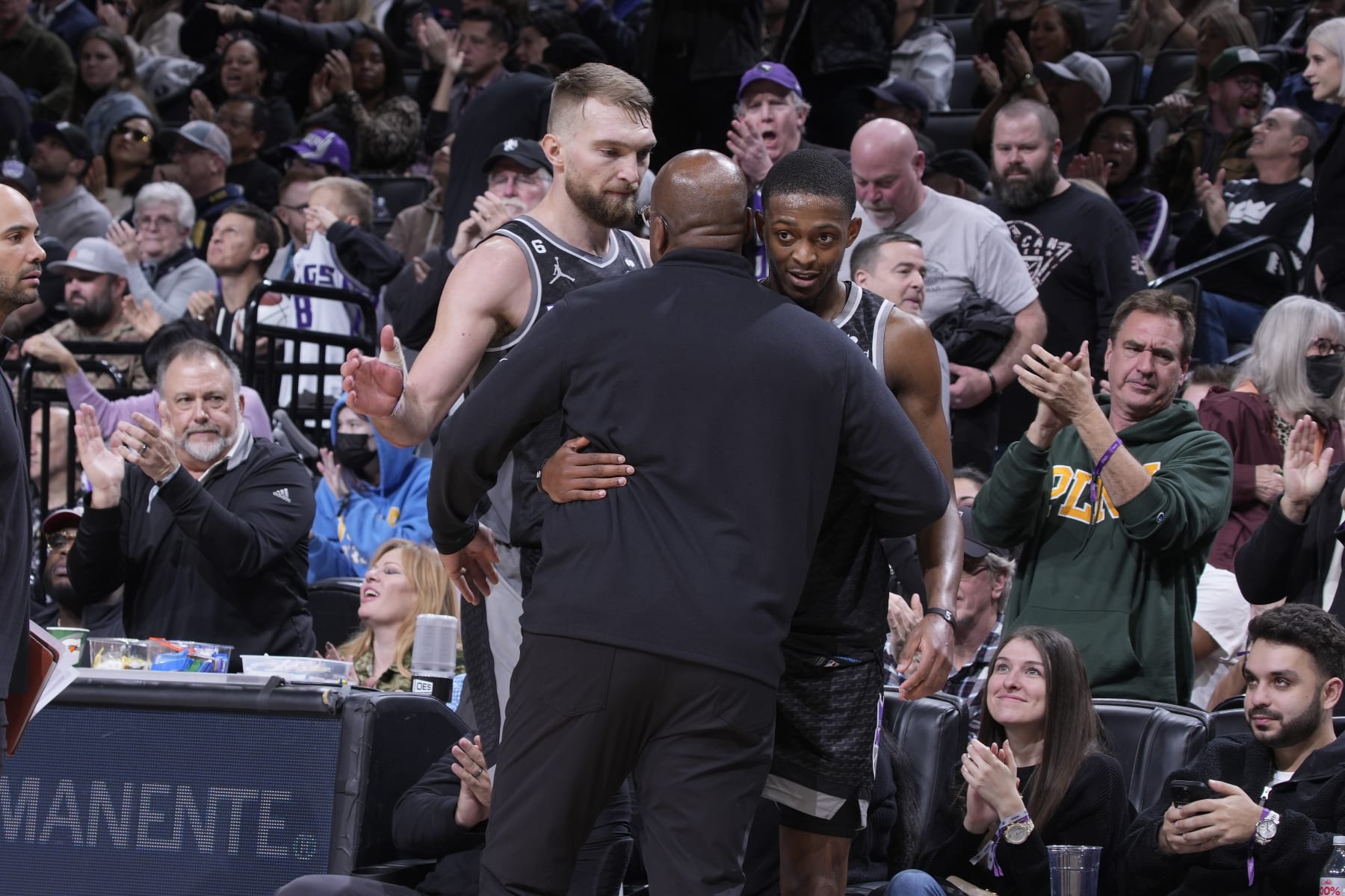 SACRAMENTO, CA - JANUARY 13: Head Coach Mike Brown, DeAaron Fox #5, and Domantas Sabonis #10 of the Sacramento Kings hug during the game against the Houston Rockets on January 13, 2023 at Golden 1 Center in Sacramento, California. NOTE TO USER: User expressly acknowledges and agrees that, by downloading and or using this photograph, User is consenting to the terms and conditions of the Getty Images Agreement. Mandatory Copyright Notice: Copyright 2023 NBAE (Photo by Rocky Widner/NBAE via Getty Images)