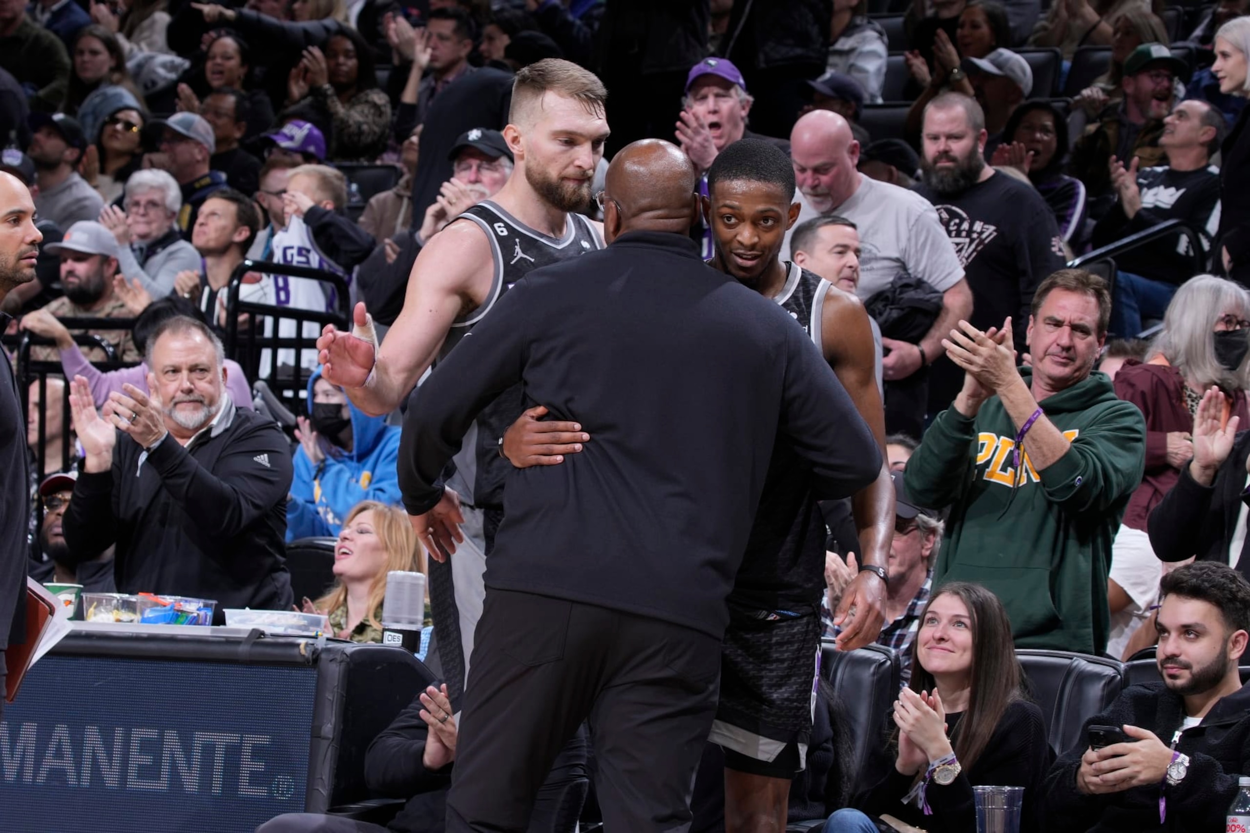 SACRAMENTO, CA - JANUARY 13: Head Coach Mike Brown, DeAaron Fox #5, and Domantas Sabonis #10 of the Sacramento Kings hug during the game against the Houston Rockets on January 13, 2023 at Golden 1 Center in Sacramento, California. NOTE TO USER: User expressly acknowledges and agrees that, by downloading and or using this photograph, User is consenting to the terms and conditions of the Getty Images Agreement. Mandatory Copyright Notice: Copyright 2023 NBAE (Photo by Rocky Widner/NBAE via Getty Images)