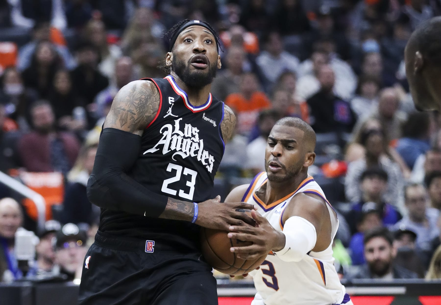 Los Angeles, CA - December 15: Phoenix Suns guard Chris Paul, right, lunges for the ball while LA Clippers forward Robert Covington drives to the basket during the second half at Crypto.com Arena on Thursday, Dec. 15, 2022 in Los Angeles, CA.(Allen J. Schaben / Los Angeles Times via Getty Images)
