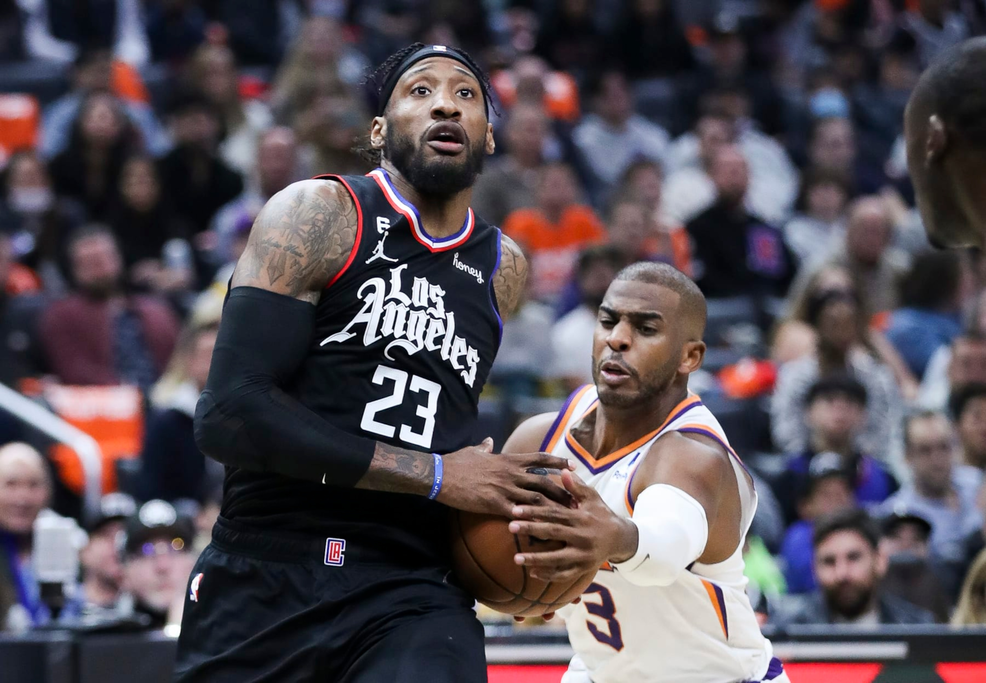 Los Angeles, CA - December 15: Phoenix Suns guard Chris Paul, right, lunges for the ball while LA Clippers forward Robert Covington drives to the basket during the second half at Crypto.com Arena on Thursday, Dec. 15, 2022 in Los Angeles, CA.(Allen J. Schaben / Los Angeles Times via Getty Images)