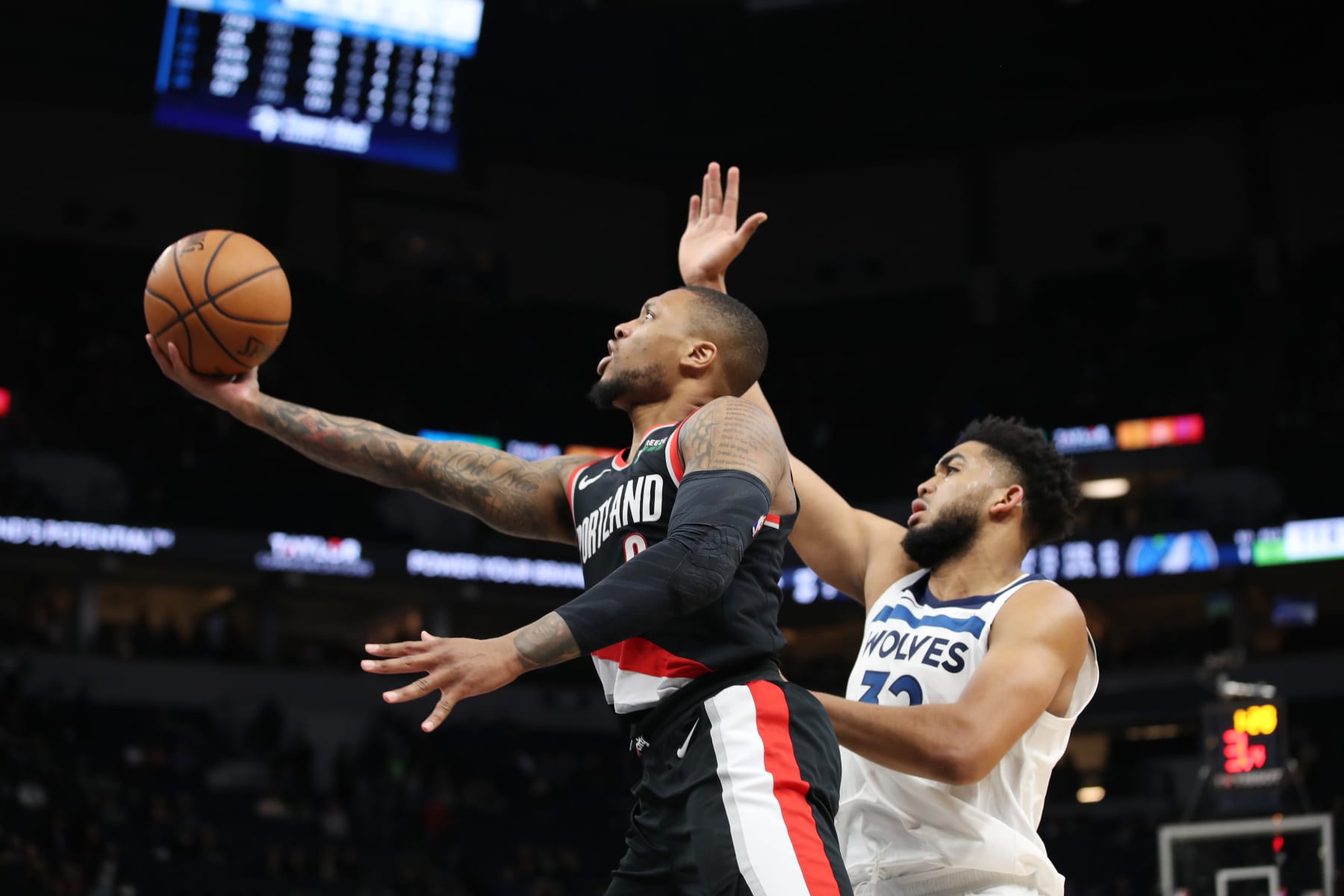 MINNEAPOLIS, MN -  APRIL 1:  Damian Lillard #0 of the Portland Trail Blazers shoots the ball against Karl-Anthony Towns #32 of the Minnesota Timberwolves during the game on April 1, 2019 at Target Center in Minneapolis, Minnesota. NOTE TO USER: User expressly acknowledges and agrees that, by downloading and or using this Photograph, user is consenting to the terms and conditions of the Getty Images License Agreement. Mandatory Copyright Notice: Copyright 2019 NBAE (Photo by Jordan Johnson/NBAE via Getty Images)
