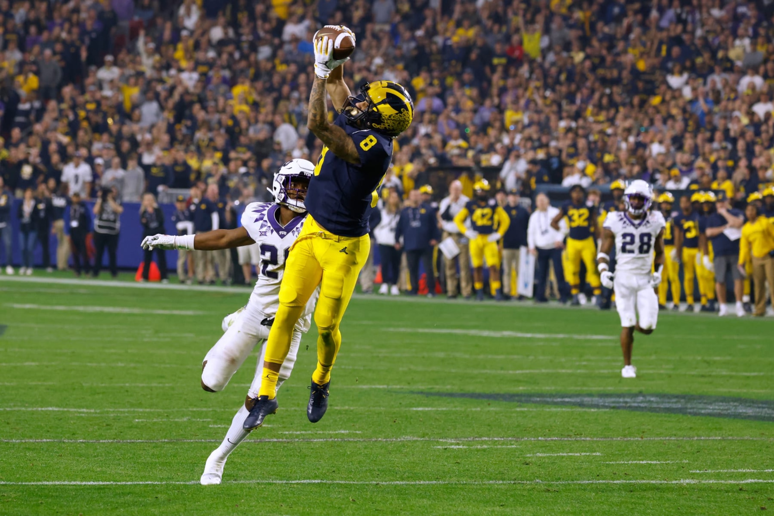 GLENDALE, AZ - DECEMBER 31: Ronnie Bell #8 of the Michigan Wolverines makes a catch against Bud Clark #26 of the TCU Horned Frogs during the second half of the Vrbo Fiesta Bowl at State Farm Stadium on December 31, 2022 in Glendale, Arizona. (Photo by Lance King/Getty Images) GLENDALE, AZ - DECEMBER 31: Ronnie Bell #8 of the Michigan Wolverines makes a catch against Bud Clark #26 of the TCU Horned Frogs during the second half of the Vrbo Fiesta Bowl at State Farm Stadium on December 31, 2022 in Glendale, Arizona. (Photo by Lance King/Getty Images)