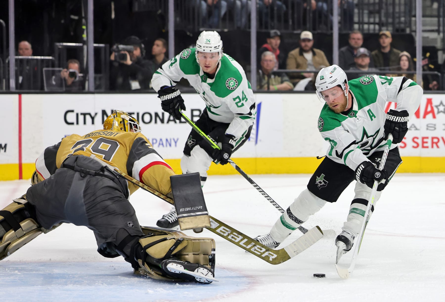 LAS VEGAS, NEVADA - FEBRUARY 25: Laurent Brossoit #39 of the Vegas Golden Knights defends the net against Joe Pavelski #16 of the Dallas Stars as Roope Hintz #24 of the Stars looks on in the first period of their game at T-Mobile Arena on February 25, 2023 in Las Vegas, Nevada. The Stars defeated Golden Knights 3-2 in a shootout. (Photo by Ethan Miller/Getty Images)