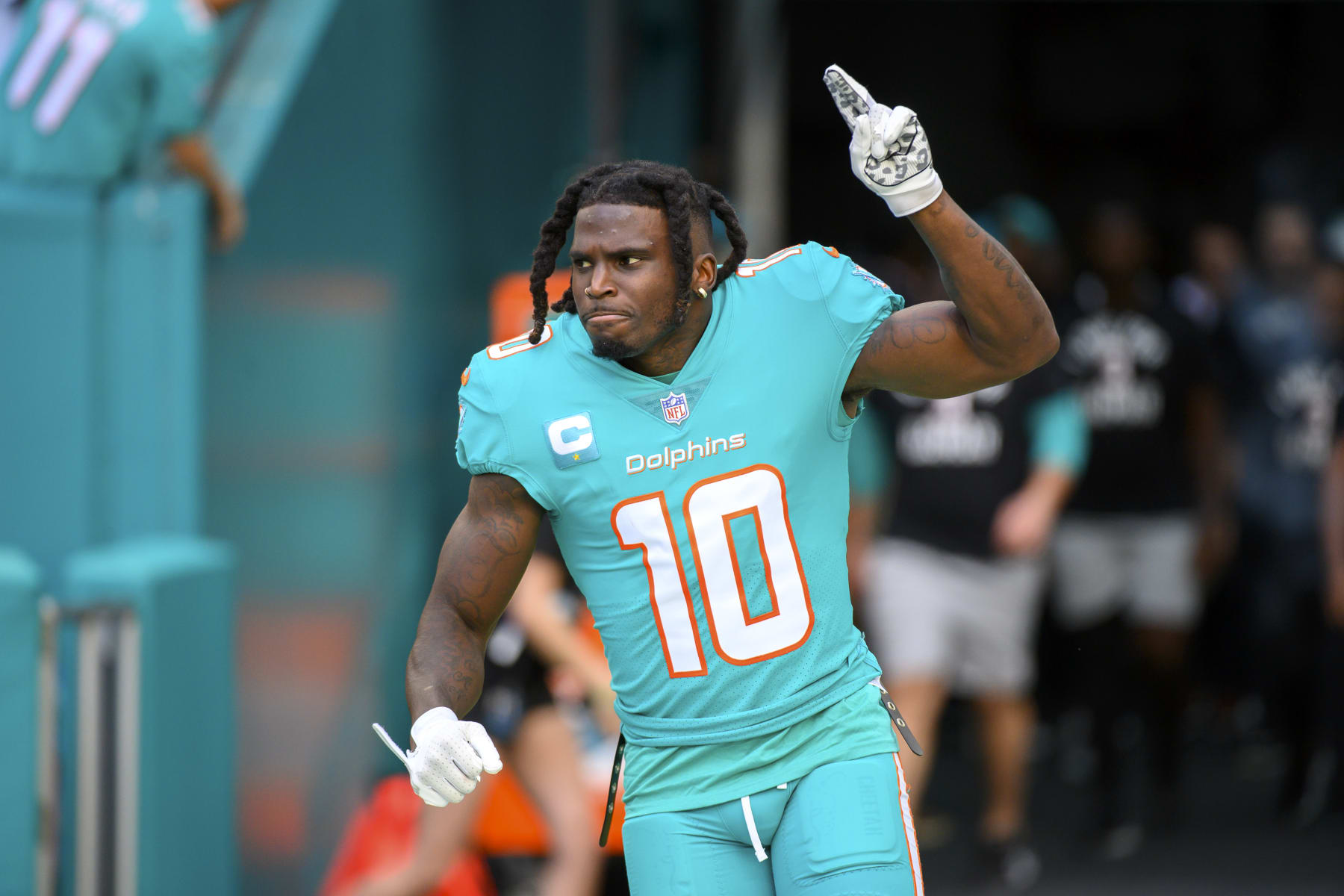Miami Dolphins wide receiver Tyreek Hill (10) points to the sky as he is introduced to the fans before an NFL football game against the New York Jets, Sunday, Jan. 8, 2023, in Miami Gardens, Fla. (AP Photo/Doug Murray)