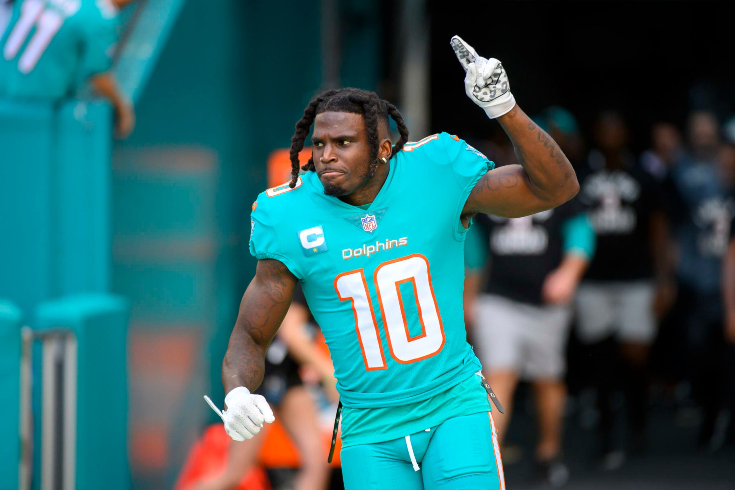 Miami Dolphins wide receiver Tyreek Hill (10) points to the sky as he is introduced to the fans before an NFL football game against the New York Jets, Sunday, Jan. 8, 2023, in Miami Gardens, Fla. (AP Photo/Doug Murray)