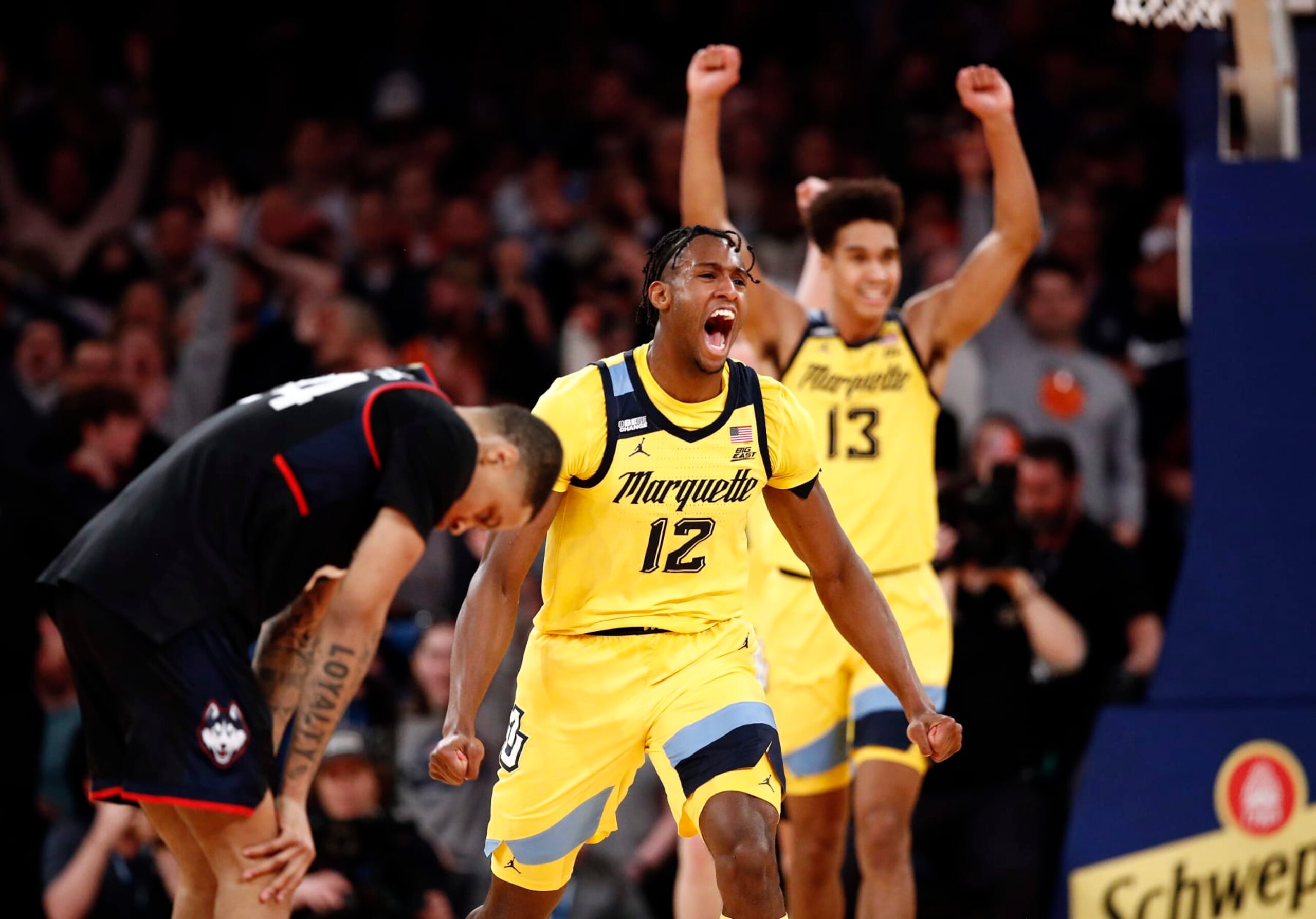 NEW YORK, NEW YORK - MARCH 10: Olivier-Maxence Prosper #12 of the Marquette Golden Eagles and Jordan Hawkins #24 of the Connecticut Huskies react after the buzzer during the second half in the Semifinal round at Madison Square Garden on March 10, 2023 in New York City. The Golden Eagles won 70-68. (Photo by Sarah Stier/Getty Images)