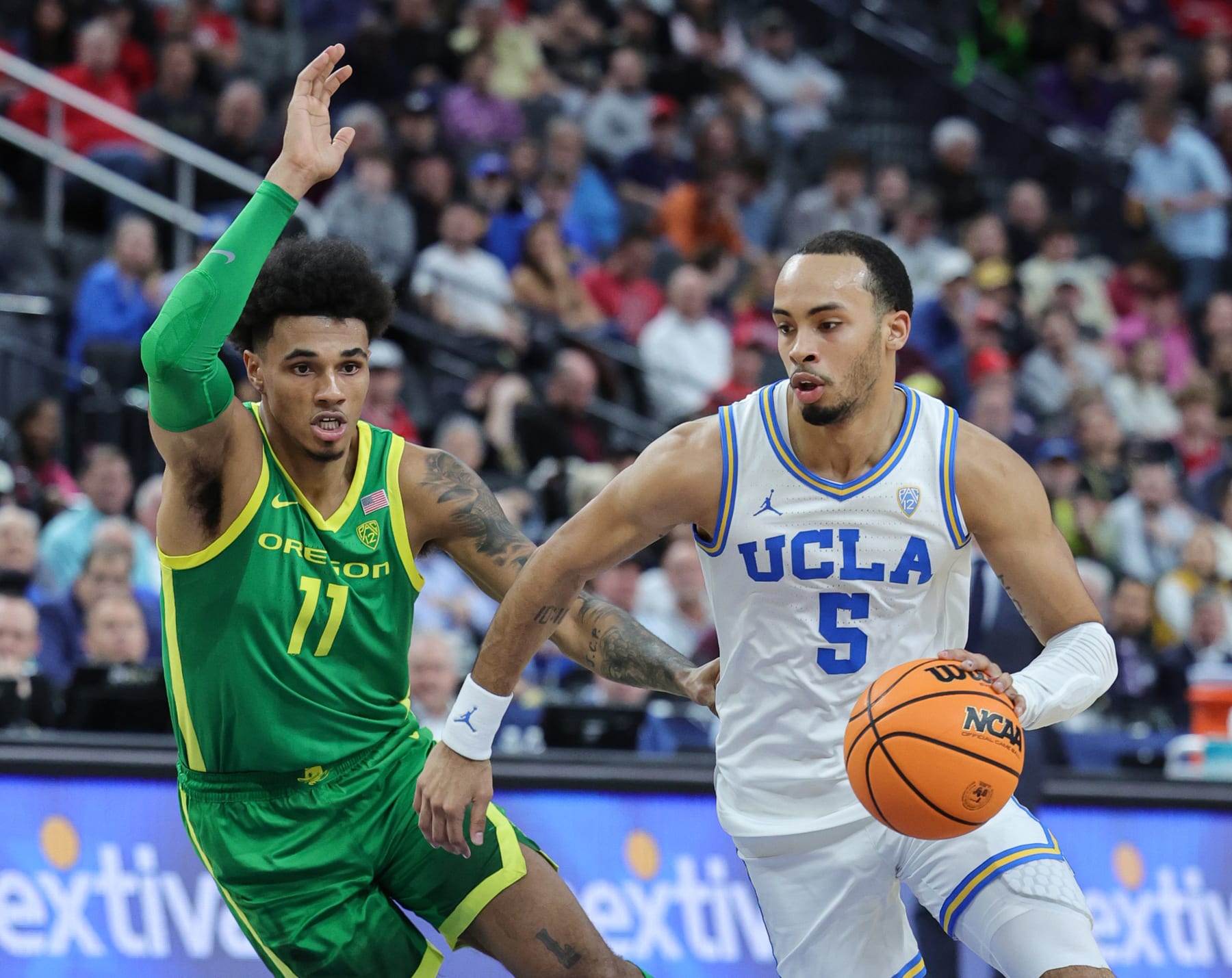 LAS VEGAS, NEVADA - MARCH 10: Amari Bailey #5 of the UCLA Bruins drives against Rivaldo Soares #11 of the Oregon Ducks in the first half of a semifinal game of the Pac-12 basketball tournament at T-Mobile Arena on March 10, 2023 in Las Vegas, Nevada. (Photo by Ethan Miller/Getty Images)