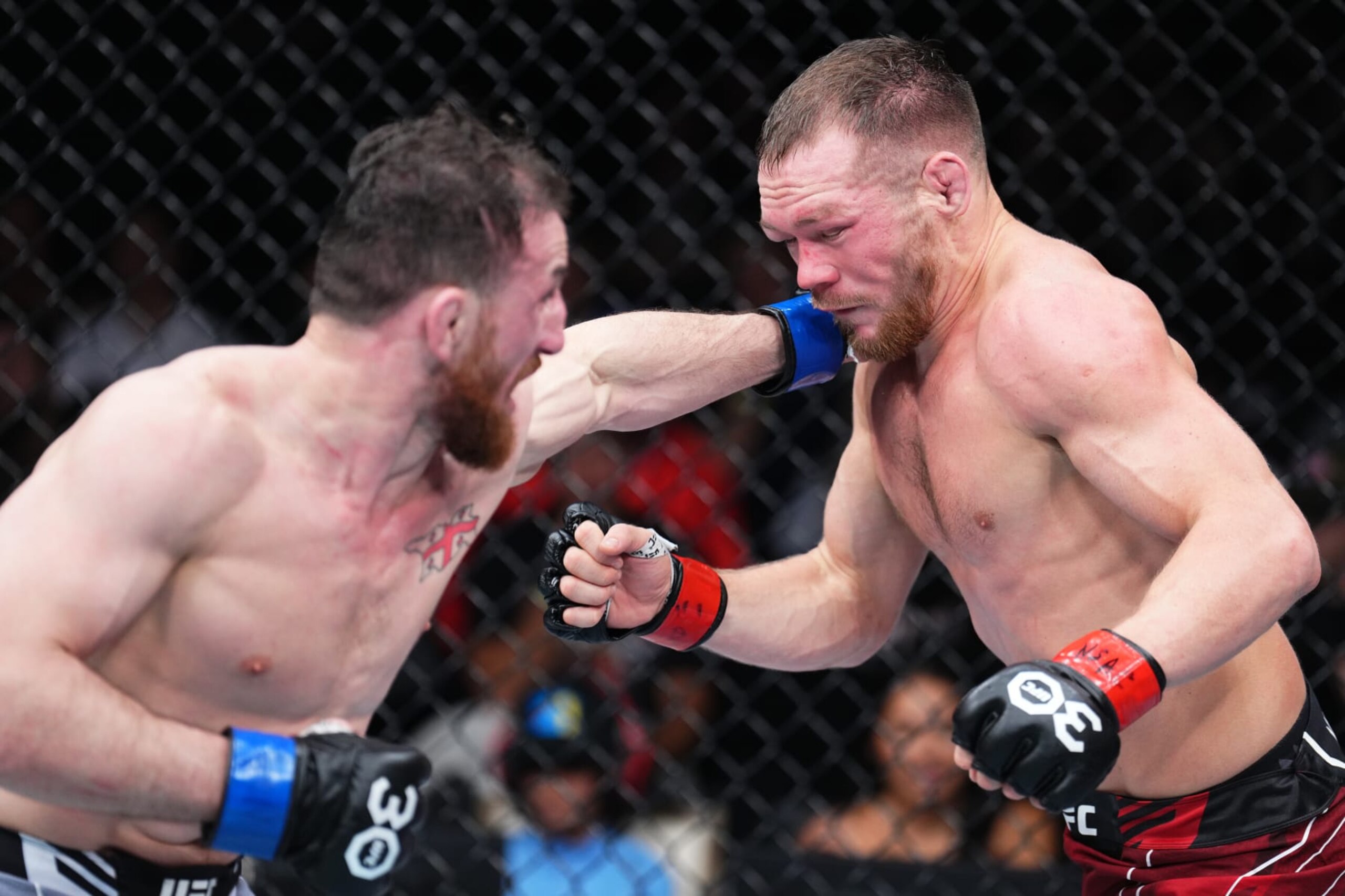 LAS VEGAS, NEVADA - MARCH 11: (L-R) Merab Dvalishvili of Georgia punches Petr Yan of Russia in a bantamweight fight during the UFC Fight Night event at The Theater at Virgin Hotels Las Vegas on March 11, 2023 in Las Vegas, Nevada. (Photo by Chris Unger/Zuffa LLC via Getty Images)
