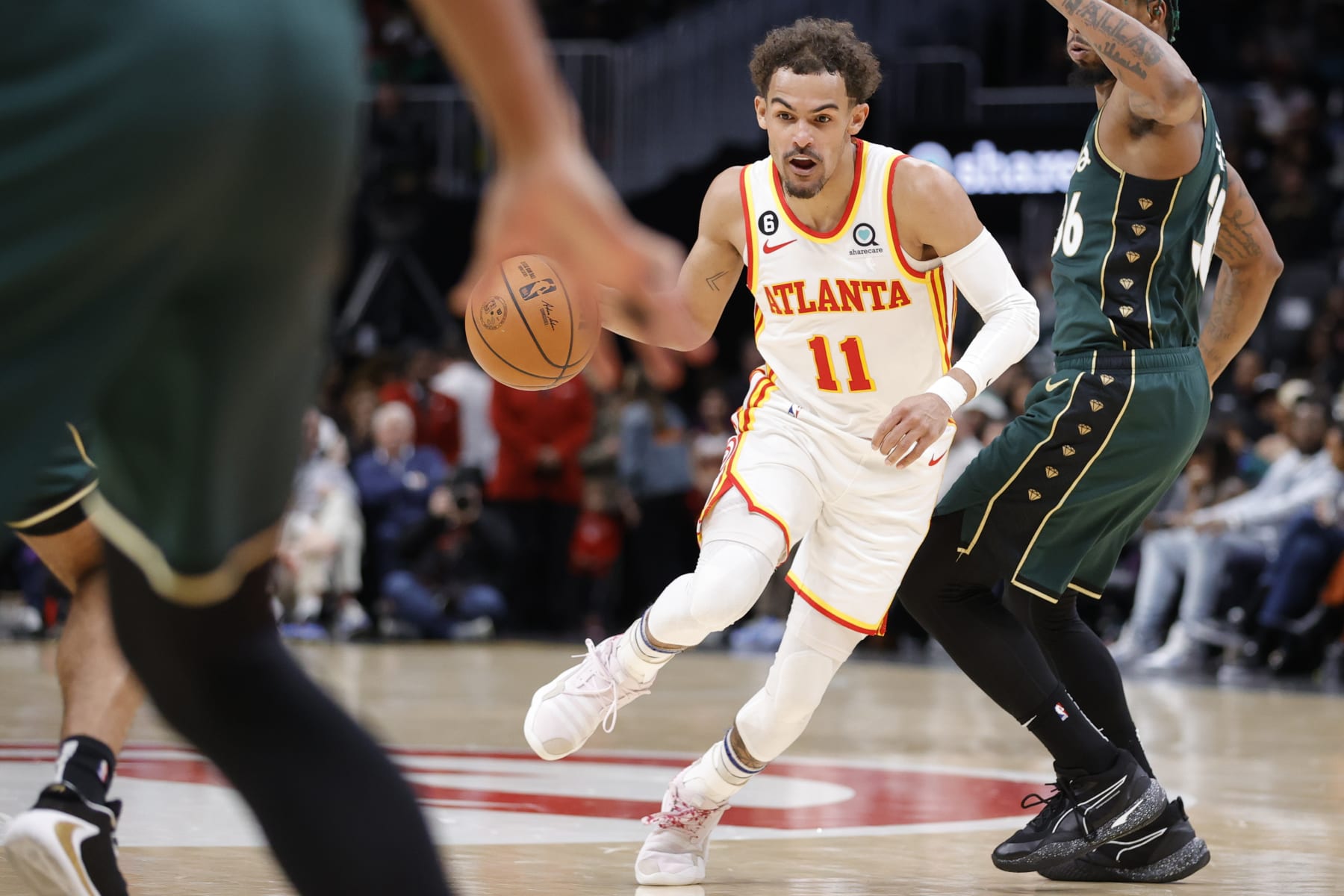 Atlanta Hawks guard Trae Young (11) drives against Boston Celtics guard Marcus Smart, right, during the first half of an NBA basketball game, Saturday, March 11, 2023, in Atlanta. (AP Photo/Alex Slitz)