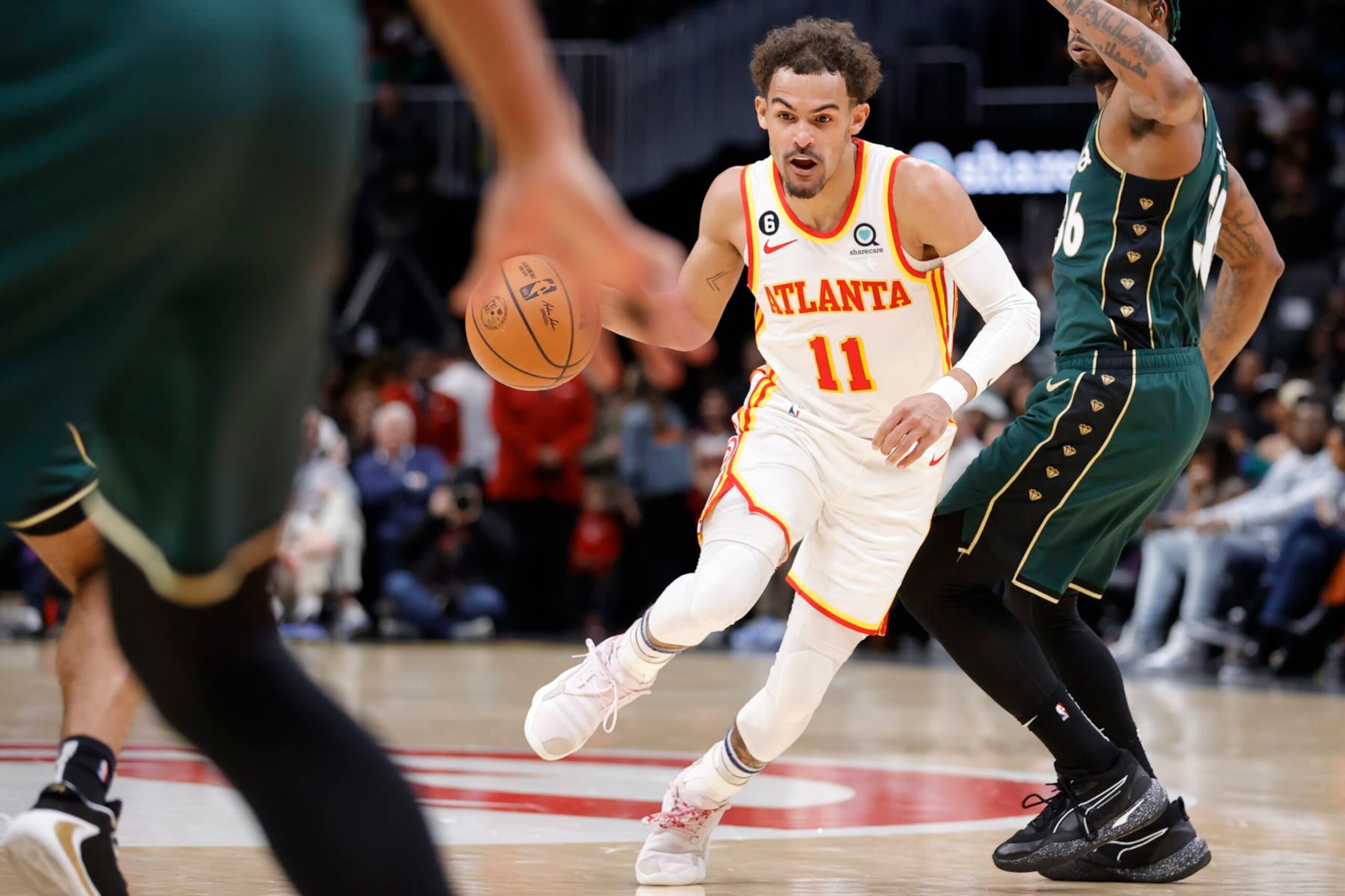 Atlanta Hawks guard Trae Young (11) drives against Boston Celtics guard Marcus Smart, right, during the first half of an NBA basketball game, Saturday, March 11, 2023, in Atlanta. (AP Photo/Alex Slitz)