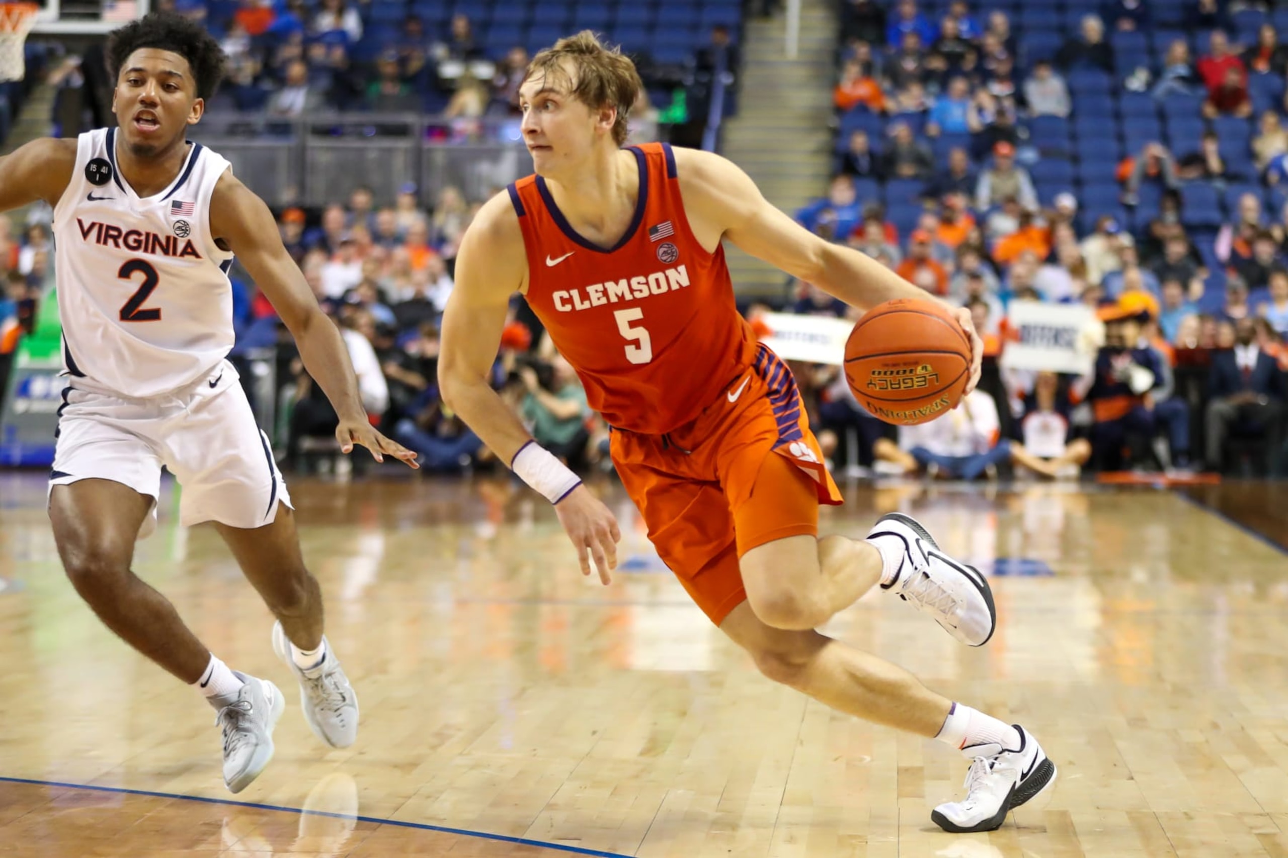 GREENSBORO, NC - MARCH 10: Reece Beekman (2) of the Virginia Cavaliers defends Hunter Tyson (5) of the Clemson Tigers as he drives to the basket during the ACC Tournament on March 10, 2023 at Greensboro Coliseum in Greensboro, NC.  (Photo by David Jensen/Icon Sportswire via Getty Images)