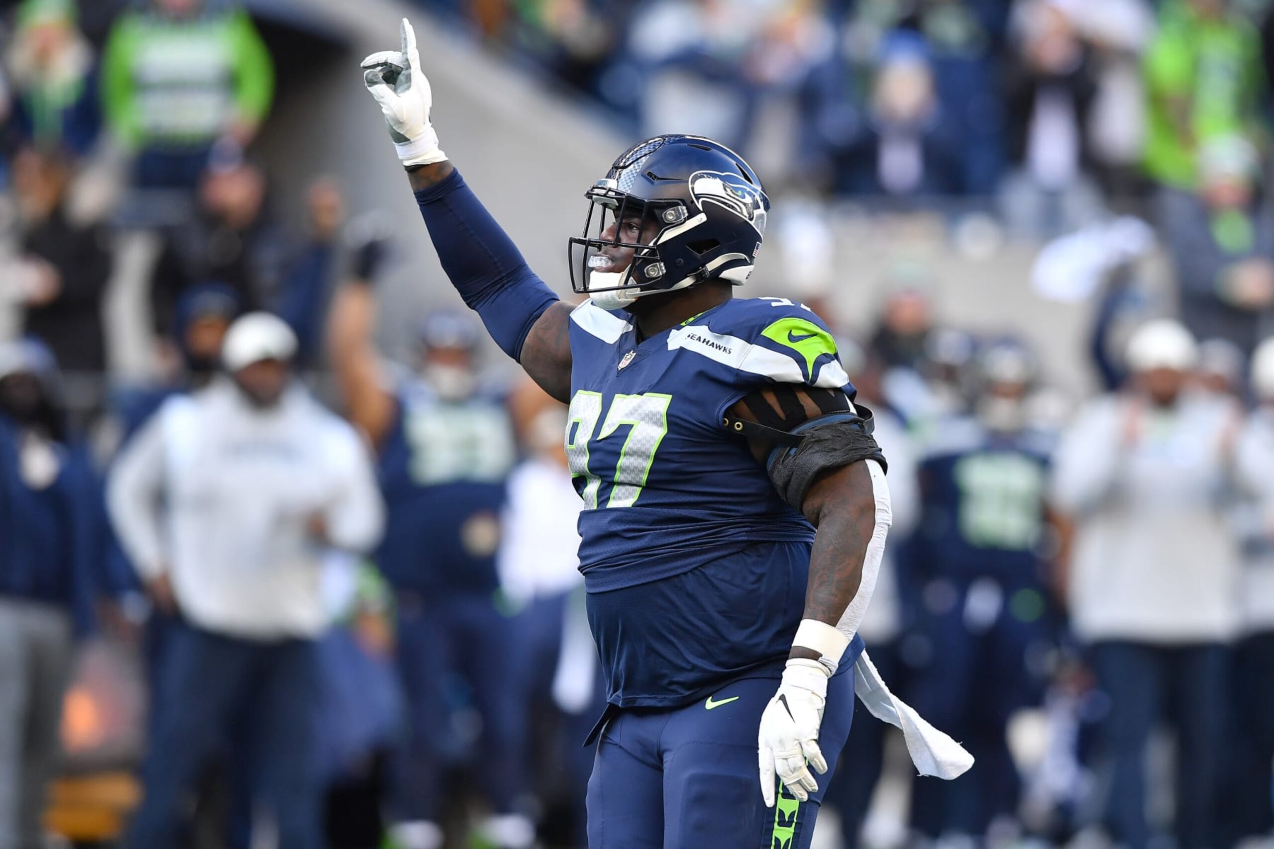 SEATTLE, WASHINGTON - NOVEMBER 27: Poona Ford #97 of the Seattle Seahawks celebrates a sack during the first half in the game against the Las Vegas Raiders at Lumen Field on November 27, 2022 in Seattle, Washington. (Photo by Jane Gershovich/Getty Images)