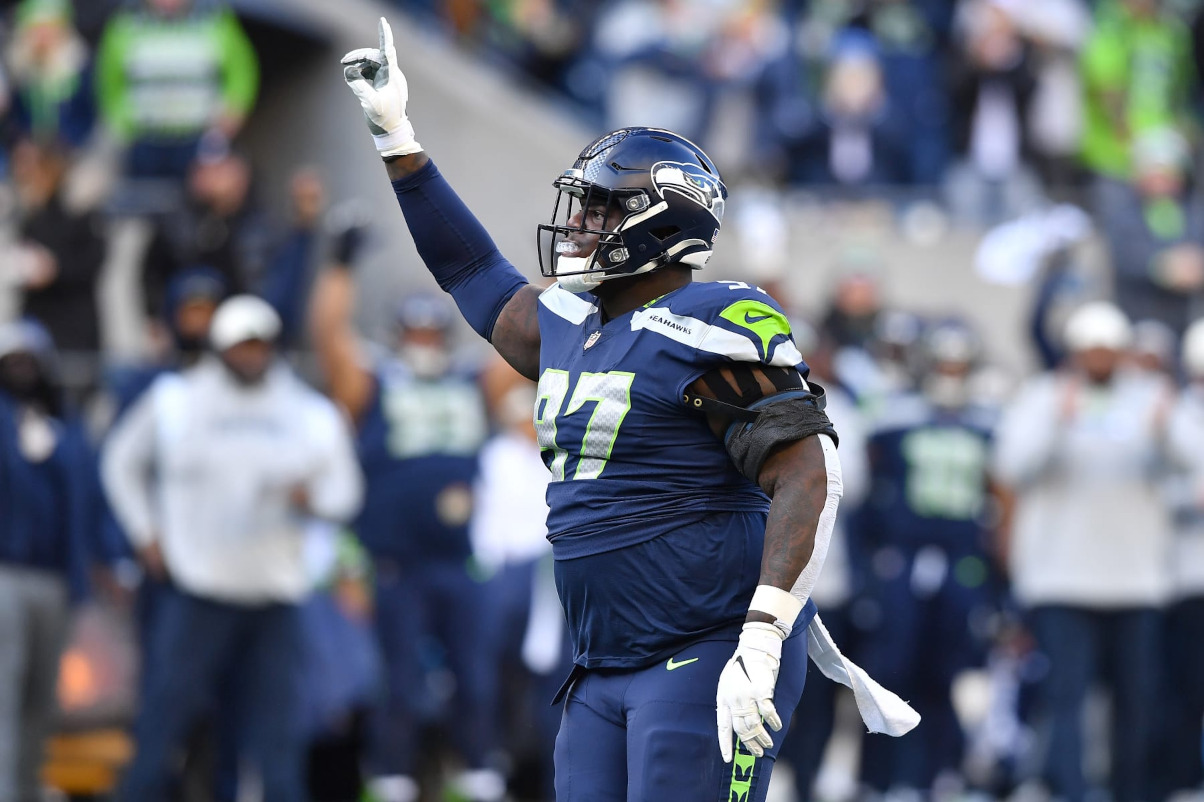 SEATTLE, WASHINGTON - NOVEMBER 27: Poona Ford #97 of the Seattle Seahawks celebrates a sack during the first half in the game against the Las Vegas Raiders at Lumen Field on November 27, 2022 in Seattle, Washington. (Photo by Jane Gershovich/Getty Images)