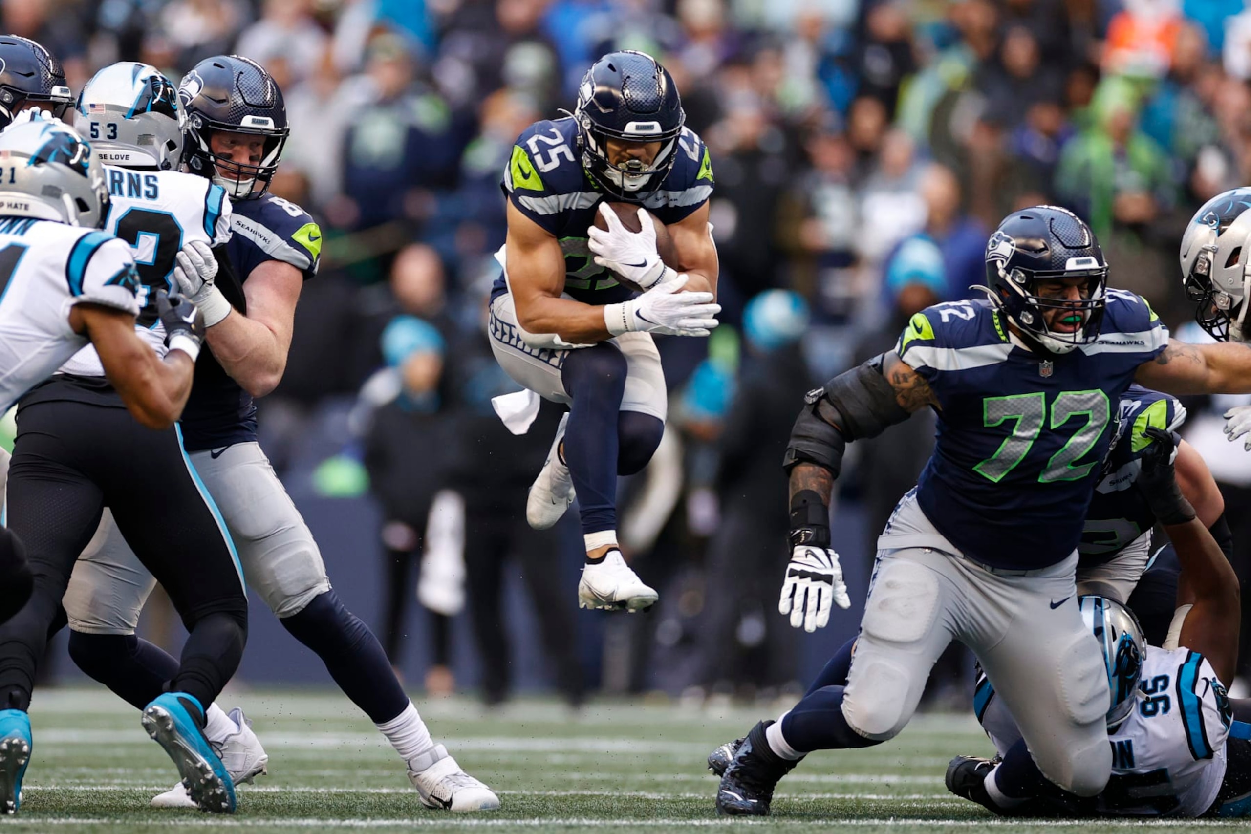 SEATTLE, WASHINGTON - DECEMBER 11: Travis Homer #25 of the Seattle Seahawks runs with the ball in the third quarter of the game against the Carolina Panthers at Lumen Field on December 11, 2022 in Seattle, Washington. (Photo by Steph Chambers/Getty Images)