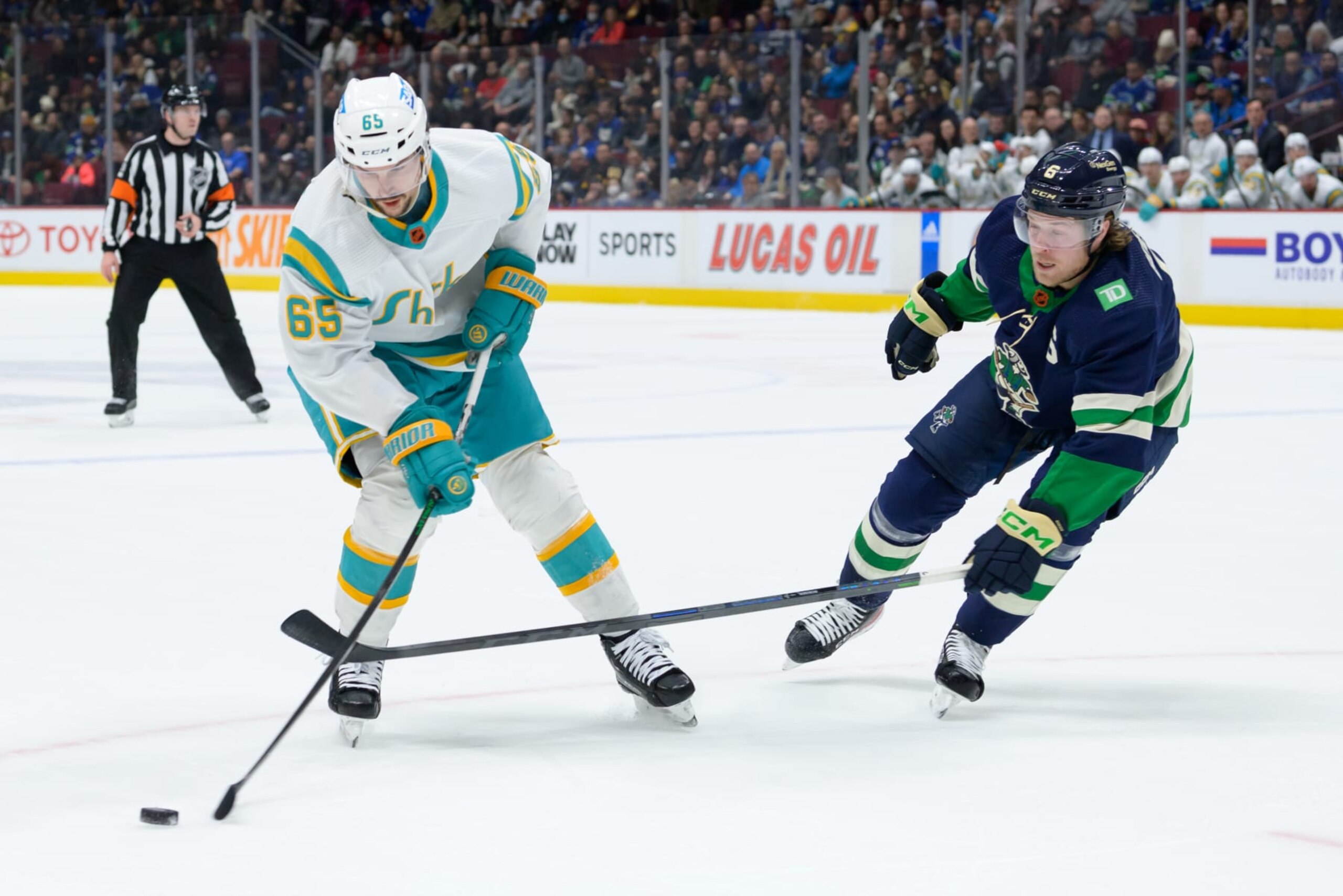 San Jose Sharks defenseman Erik Karlsson (left) and Vancouver Canucks winger Brock Boeser