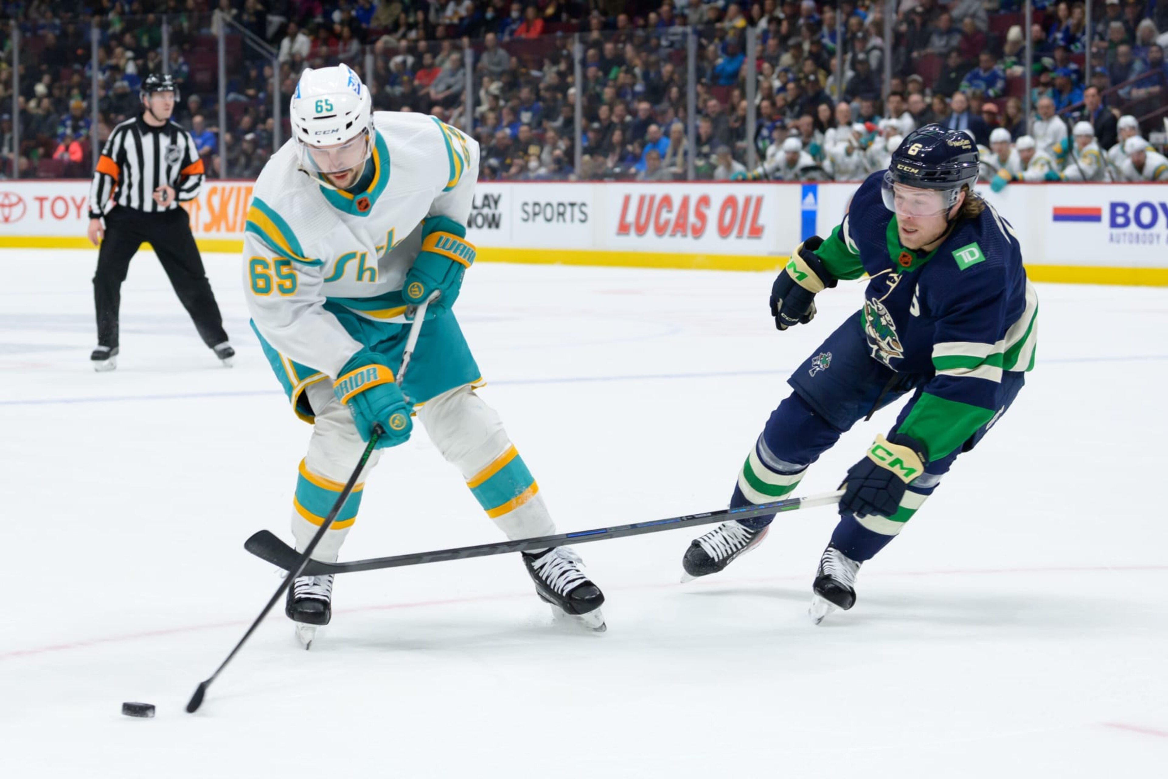 San Jose Sharks defenseman Erik Karlsson (left) and Vancouver Canucks winger Brock Boeser