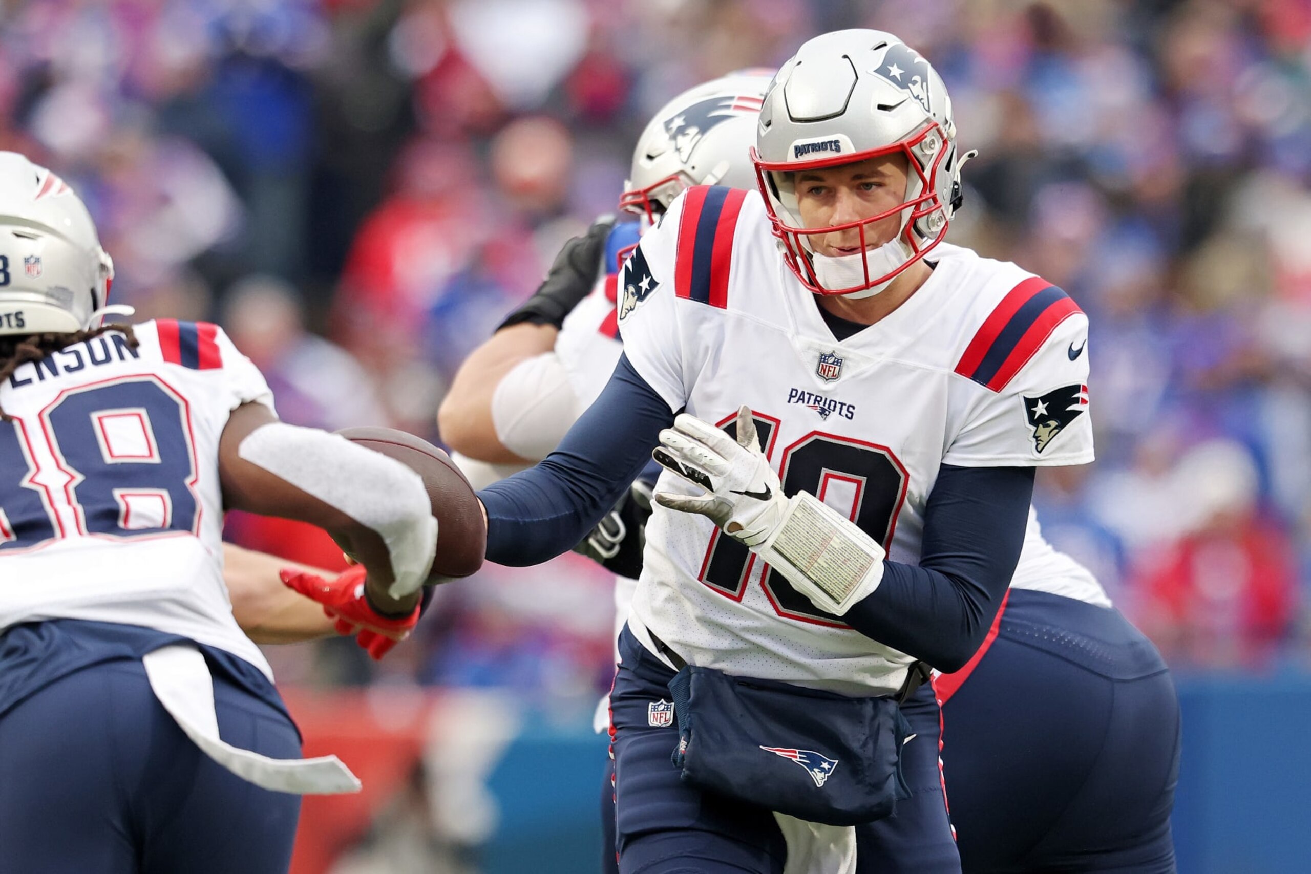 ORCHARD PARK, NEW YORK - JANUARY 08: Mac Jones #10 of the New England Patriots hands the ball off to Rhamondre Stevenson #38 of the New England Patriots during the second quarter against the Buffalo Bills at Highmark Stadium on January 08, 2023 in Orchard Park, New York. (Photo by Bryan M. Bennett/Getty Images)