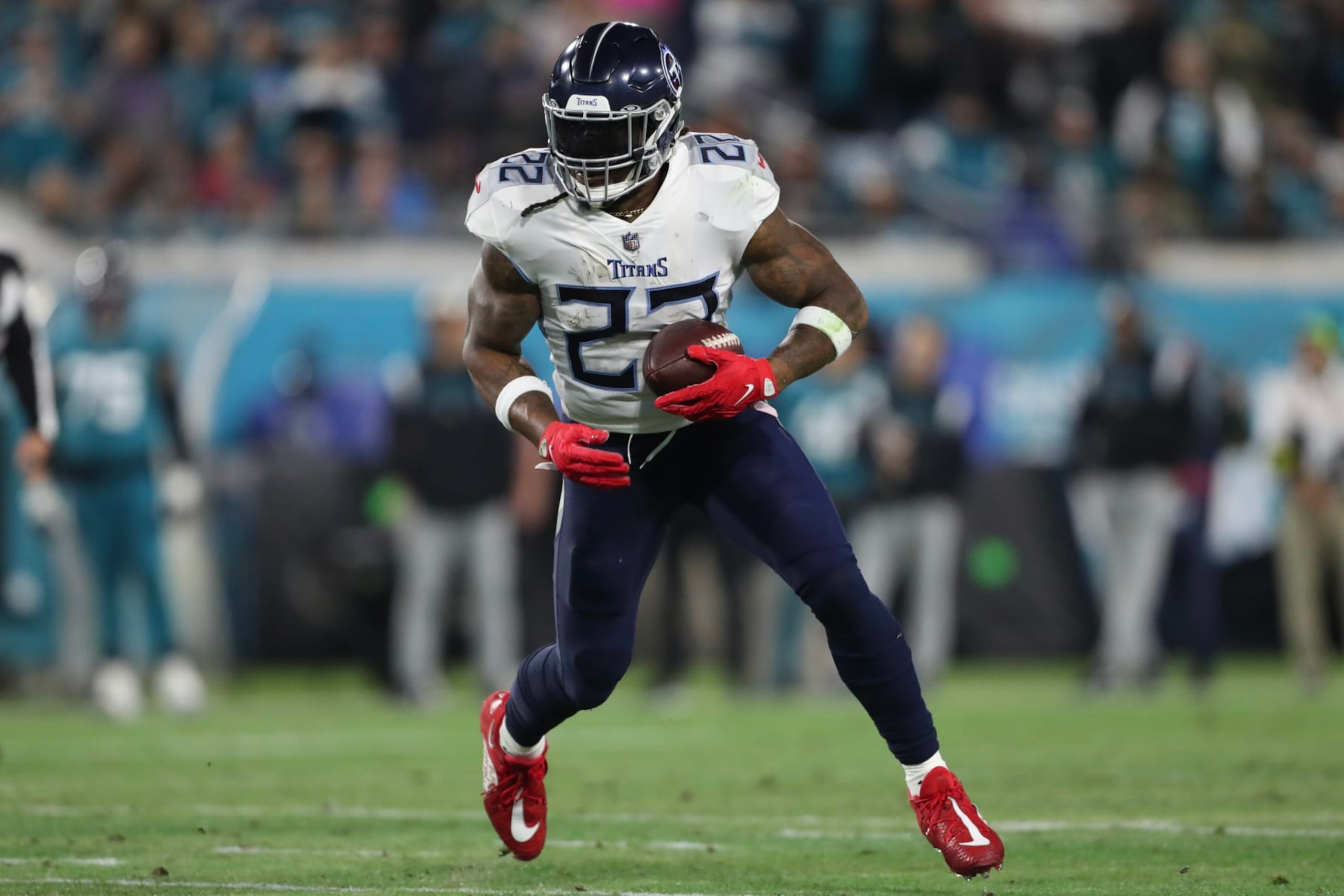 JACKSONVILLE, FLORIDA - JANUARY 07: Derrick Henry #22 of the Tennessee Titans carries the ball during the first half against the Jacksonville Jaguars at TIAA Bank Field on January 07, 2023 in Jacksonville, Florida. (Photo by Courtney Culbreath/Getty Images)